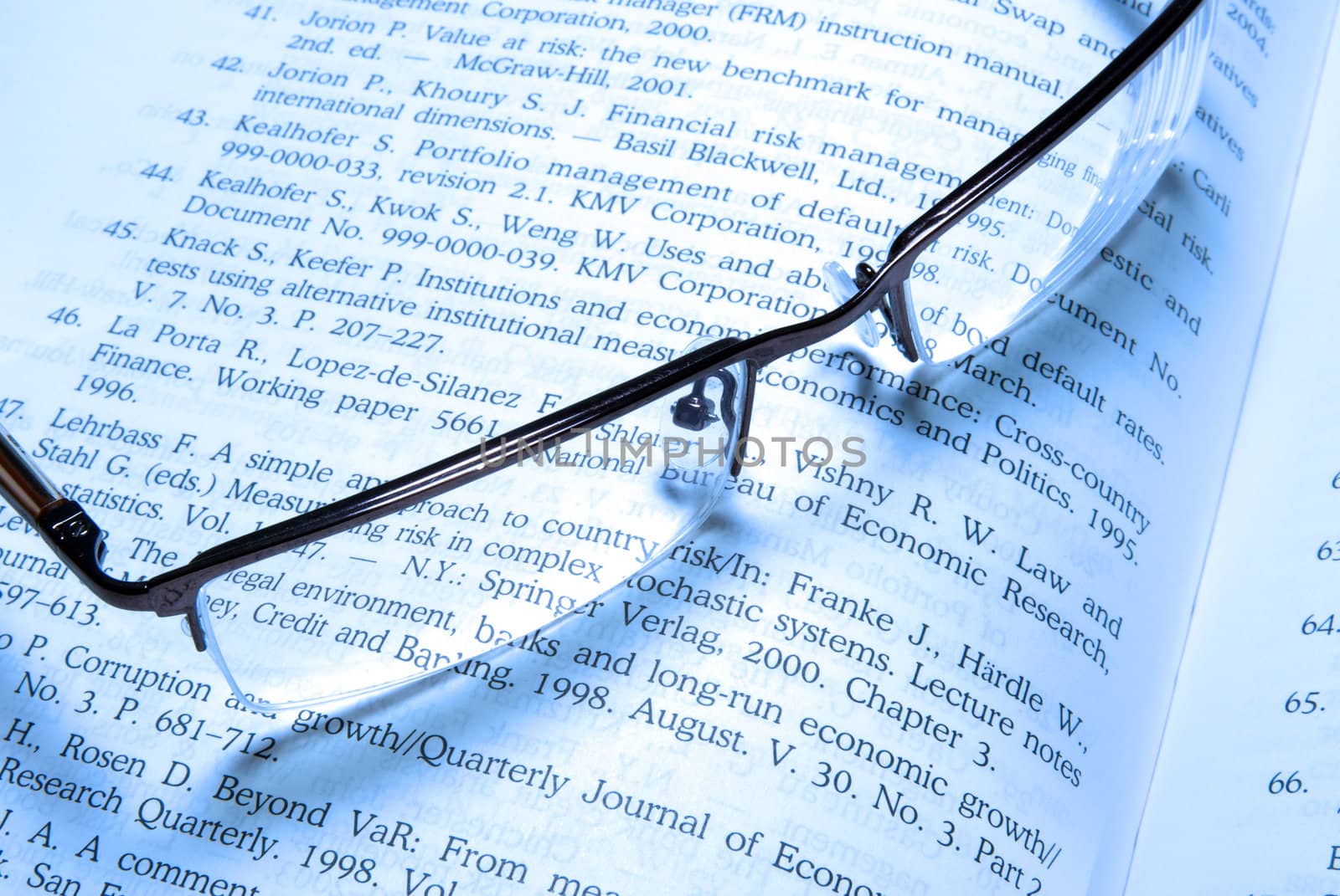 Glasses laying on book. by borodaev