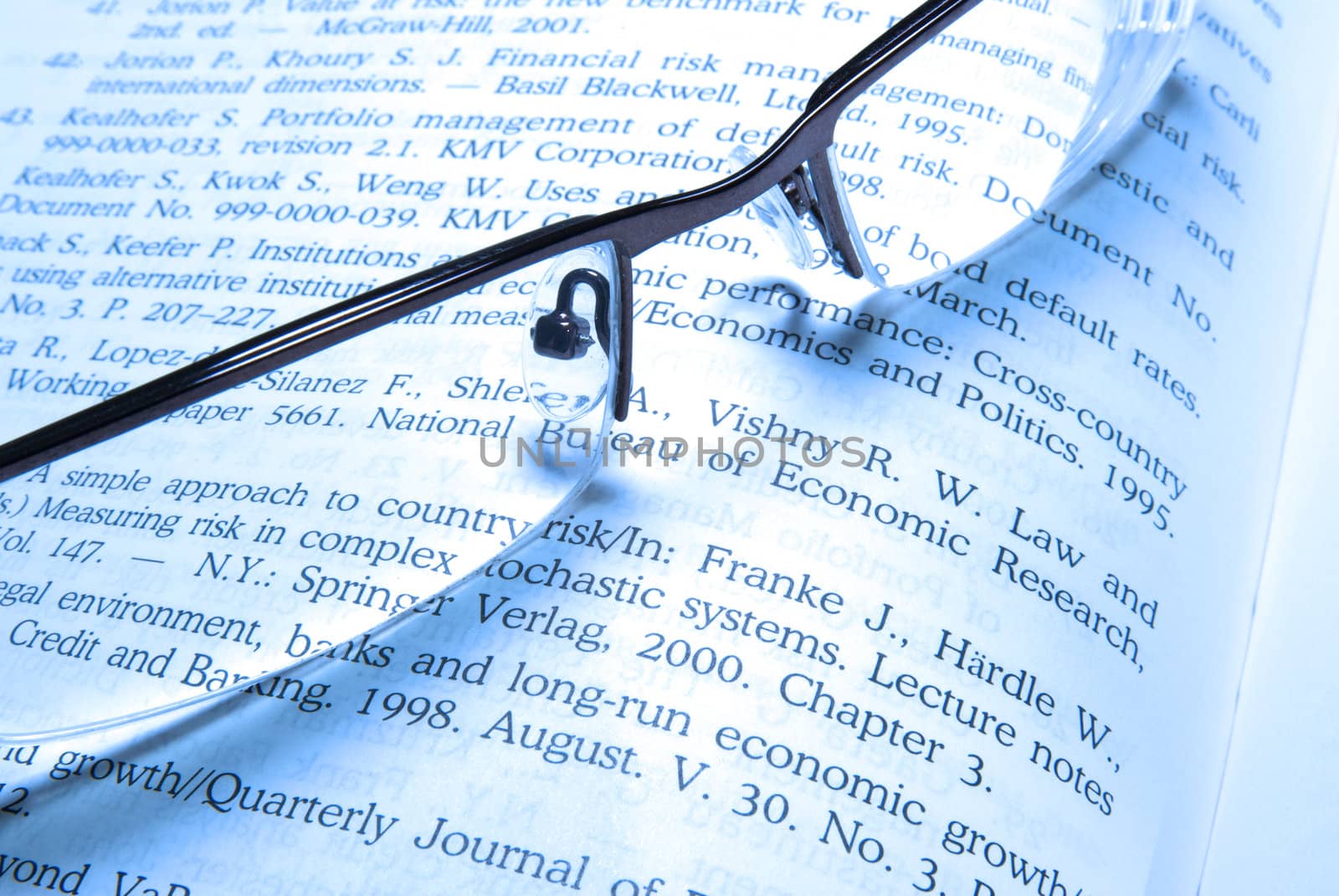 Glasses laying on financial book. 