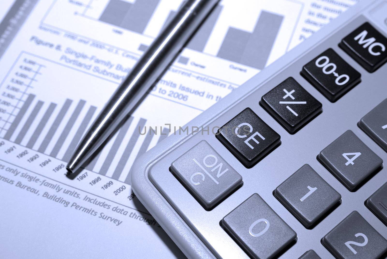 Calculator, steel pen and financial analysis report. by borodaev