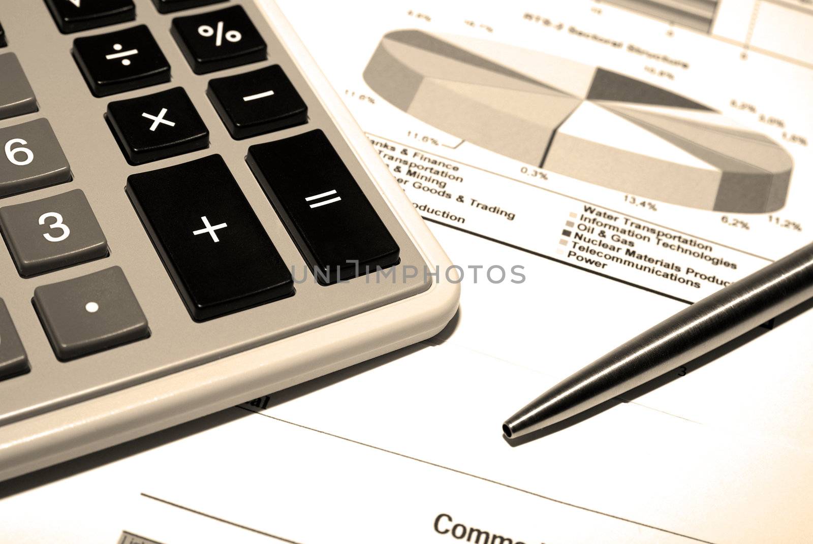 Calculator and steel pen on printed financial data. by borodaev