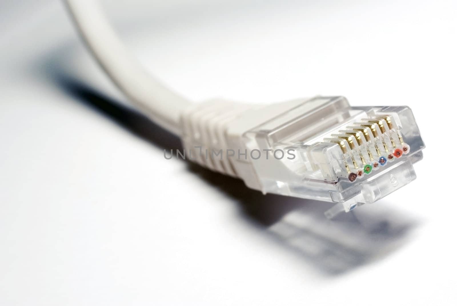 UTP cable closeup on white background. Focus on RJ45.