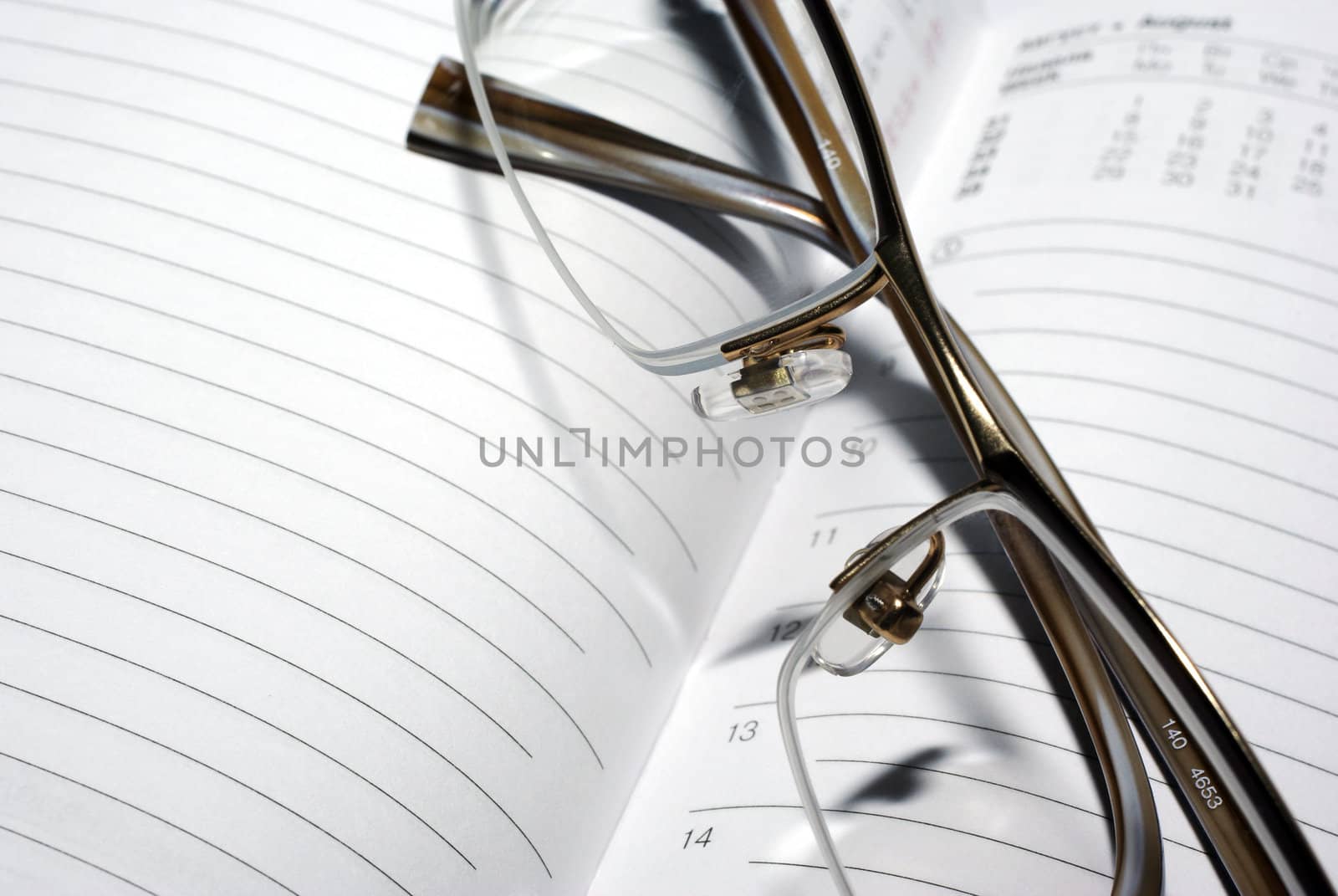 Glasses laying on agenda organizer. Business concept.