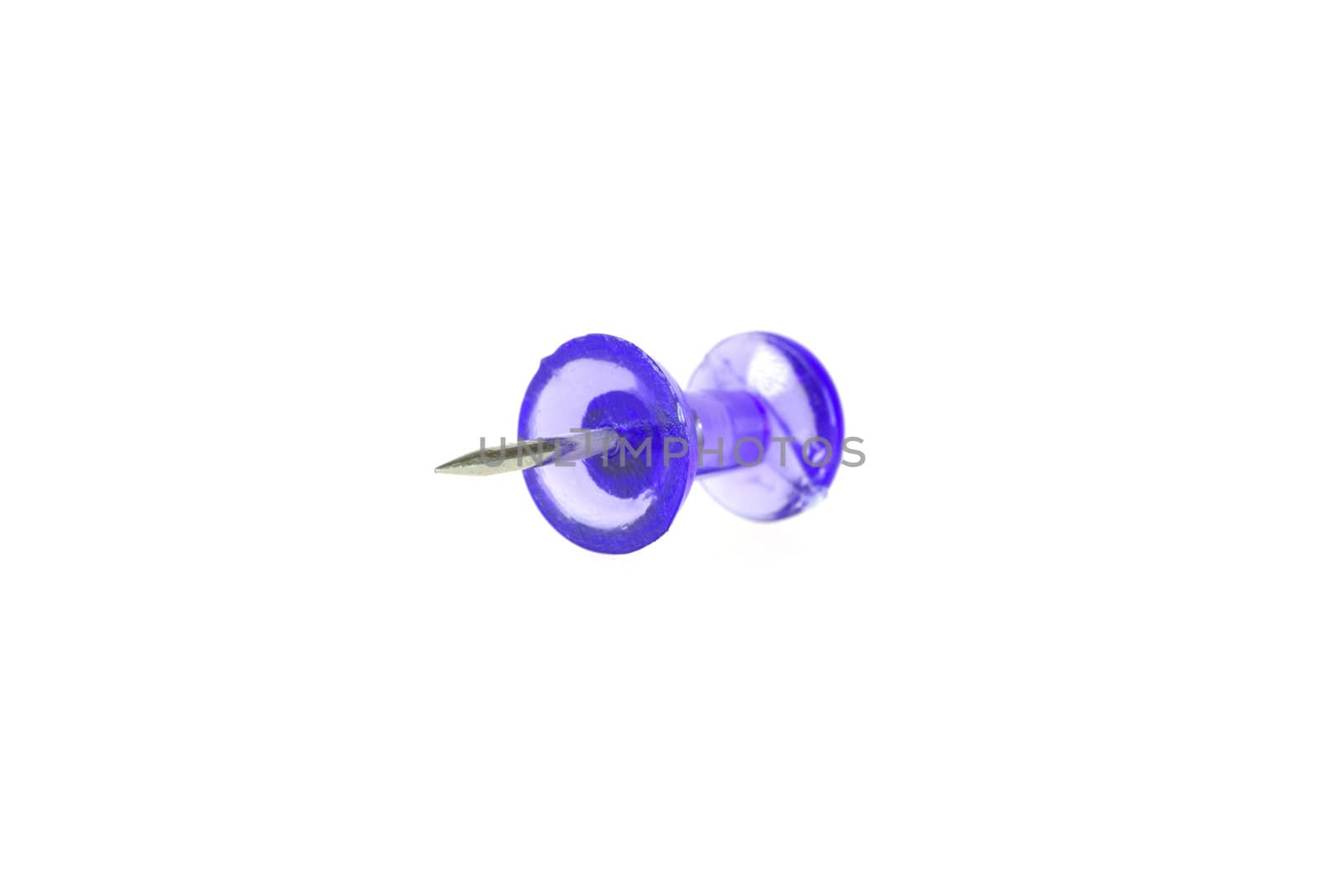 Close-up of violet transparent plastic drawing pin isolated on white background.