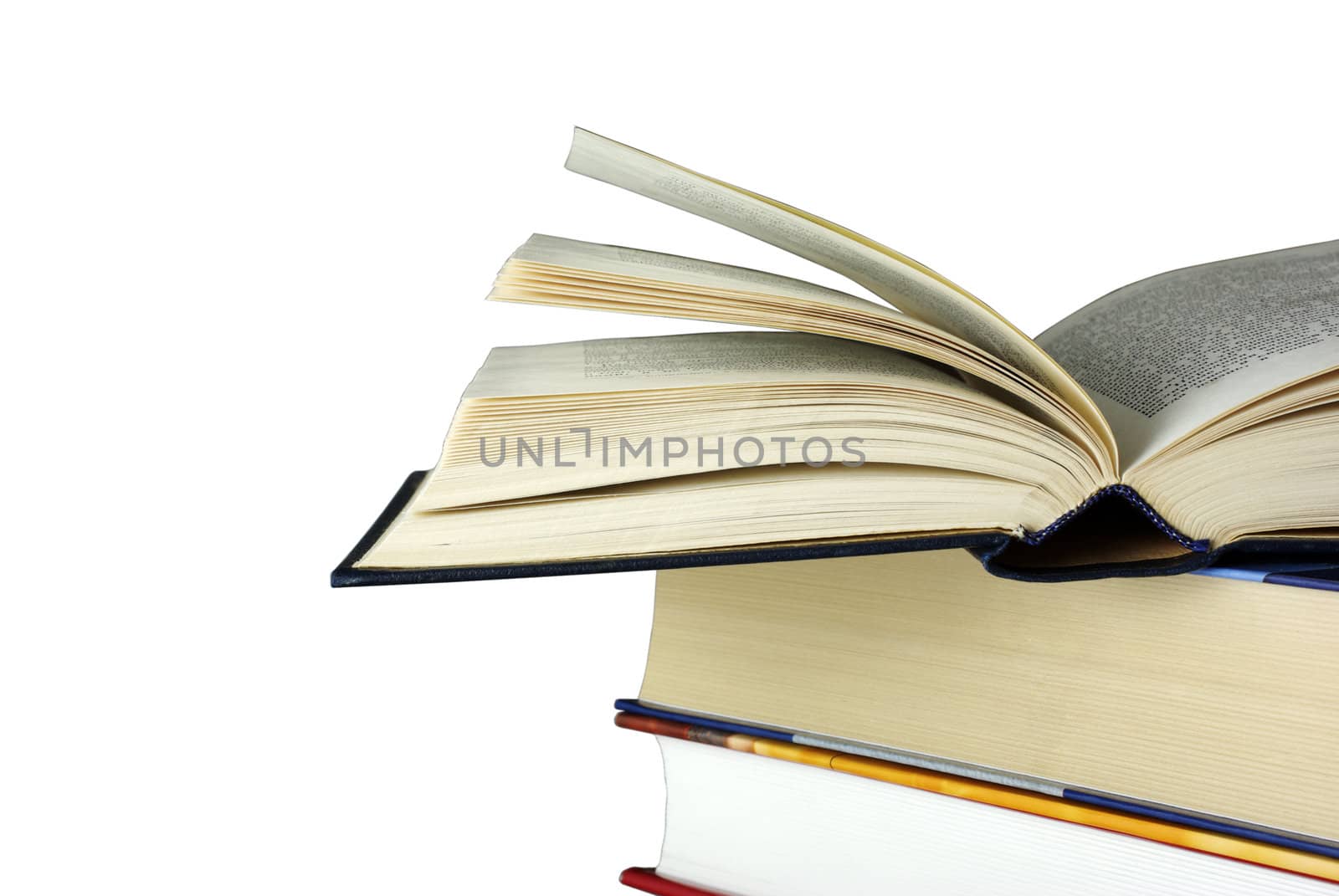 Opened book laying on other books isolated on white. Clipping pa by borodaev