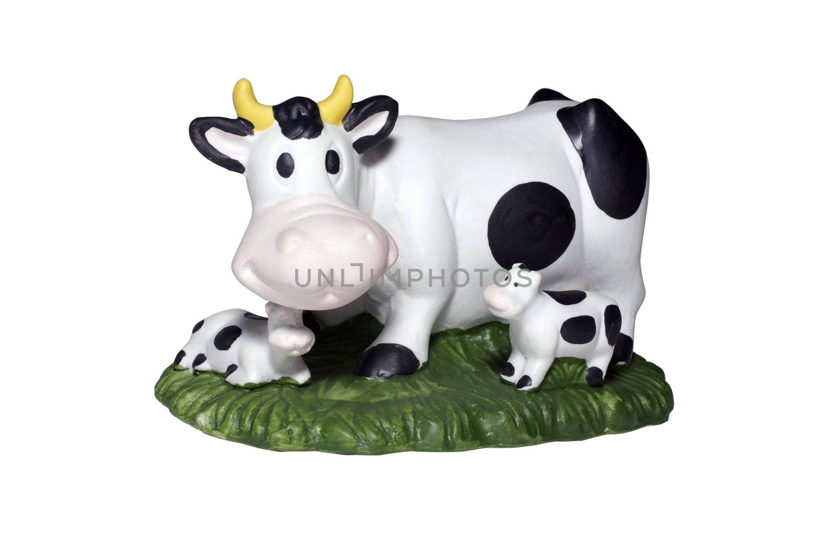 Cow and two calf on green lawn toy. Isolated on white background. Clipping path.