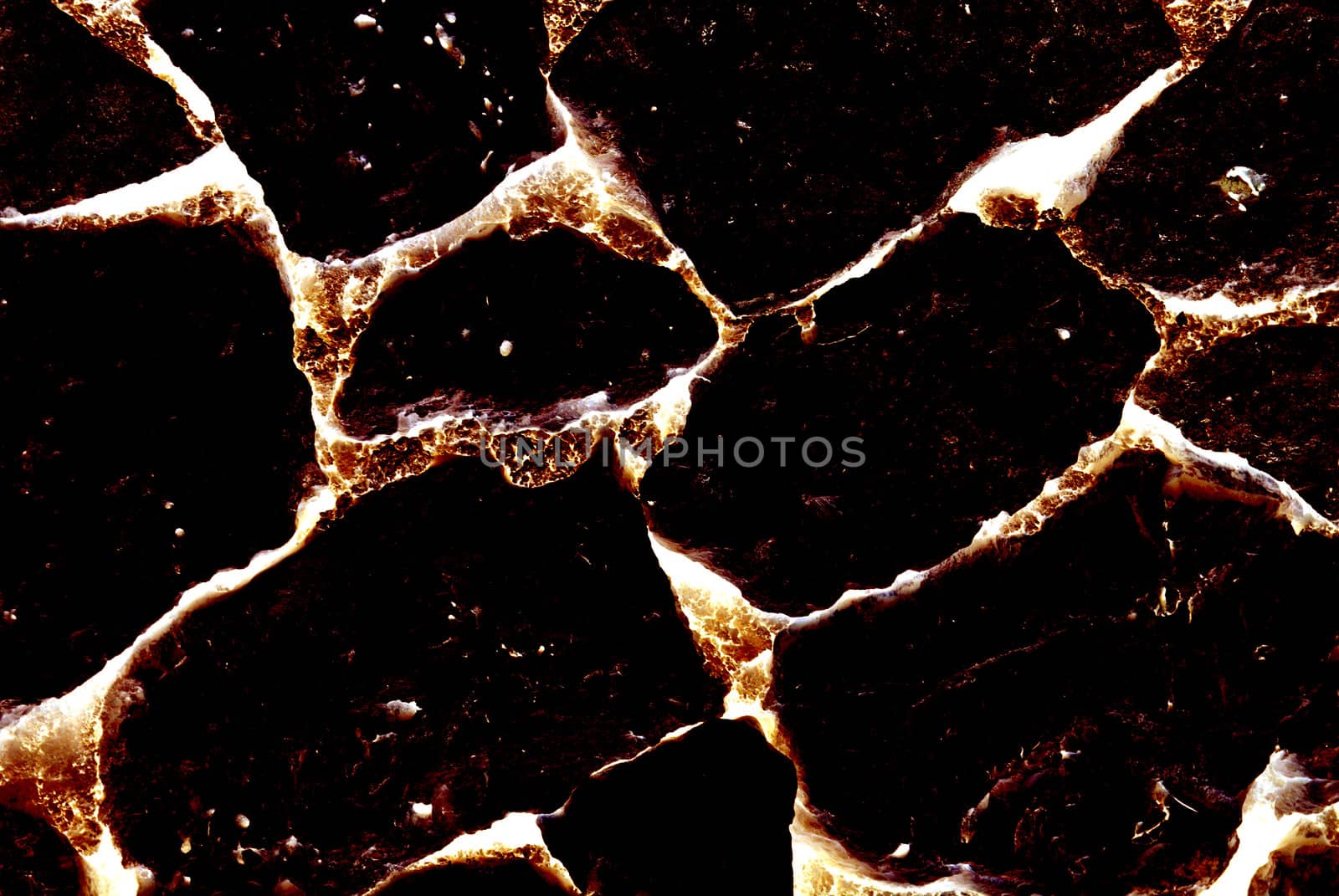 Close-up of burnt volcanic stone. Abstract textured background. by borodaev