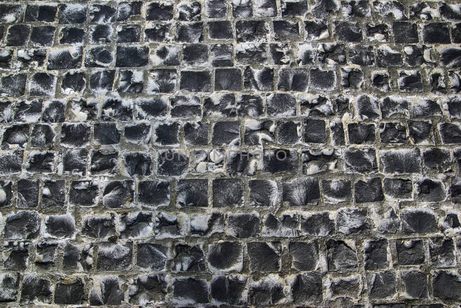 Old road made of stone bricks. Abstract texture background.