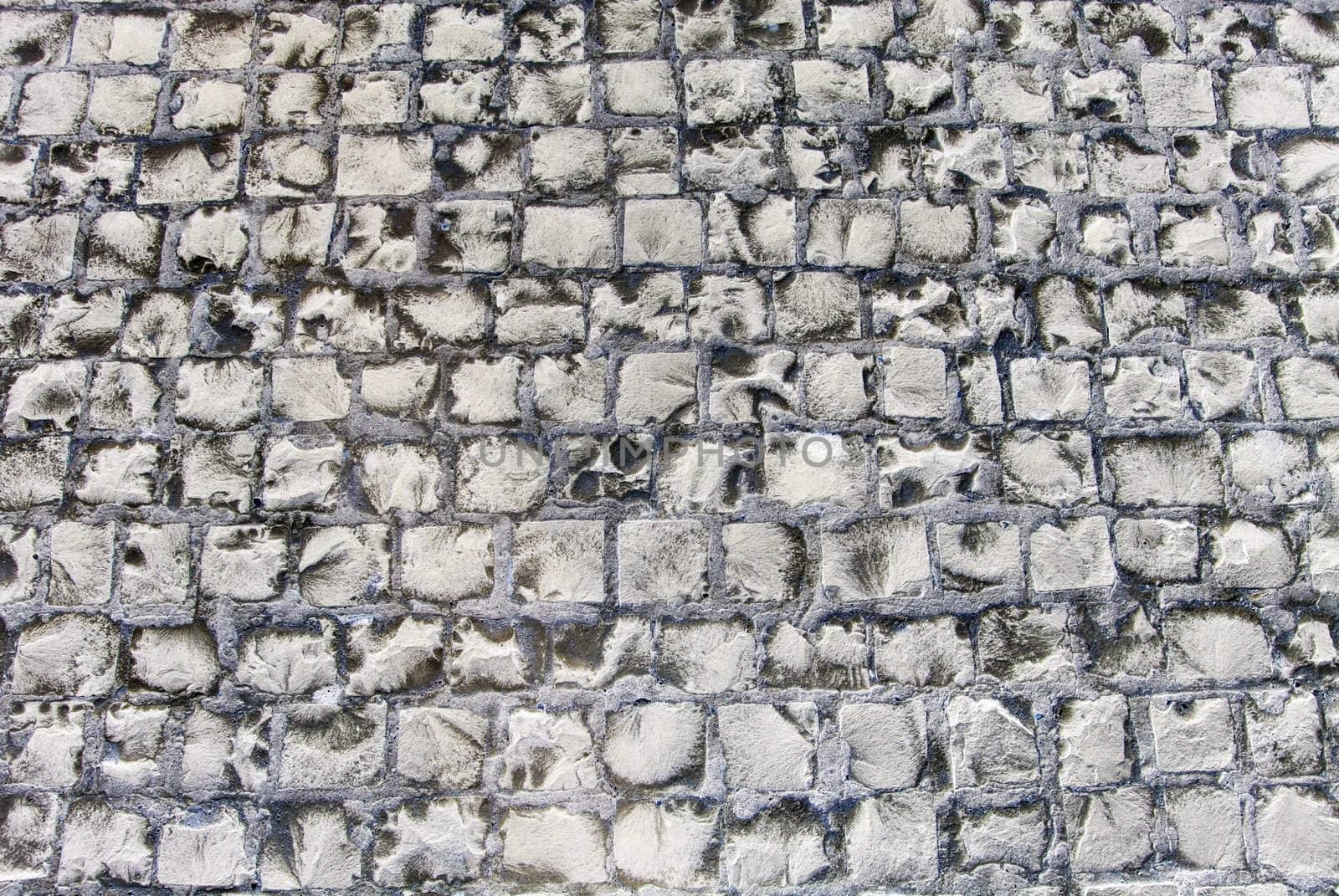 Old road made of stone bricks. Abstract texture background.