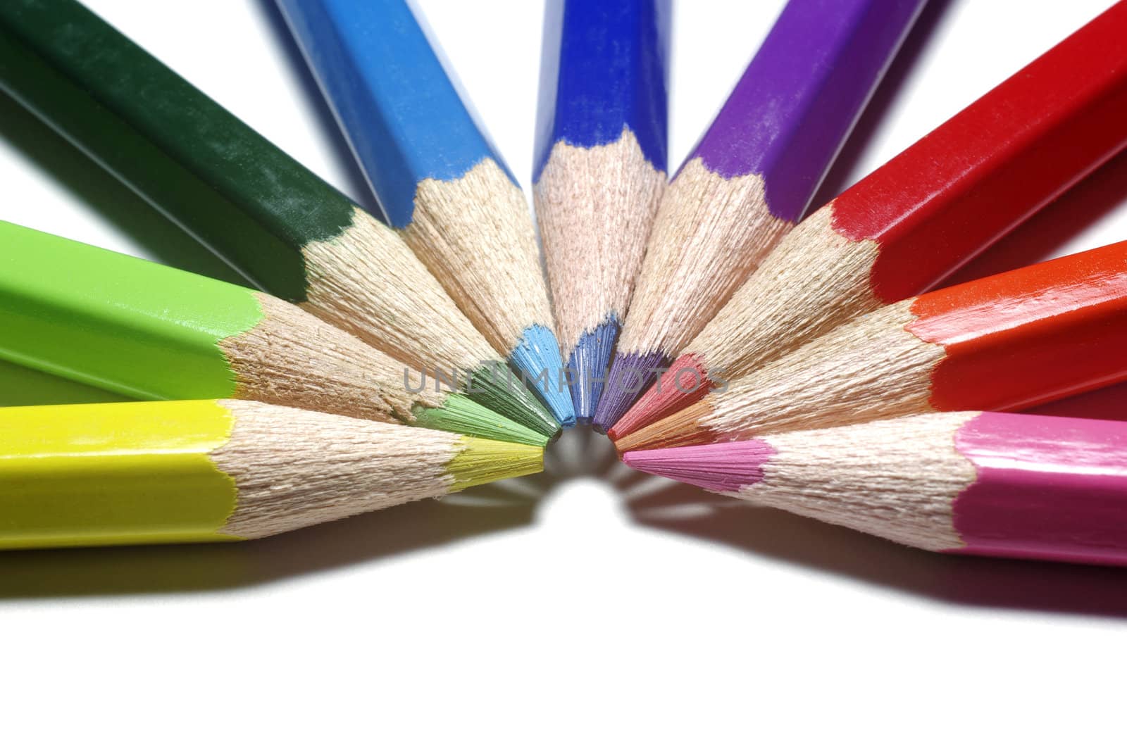 Half-circle of colour pencils isolated on white background.