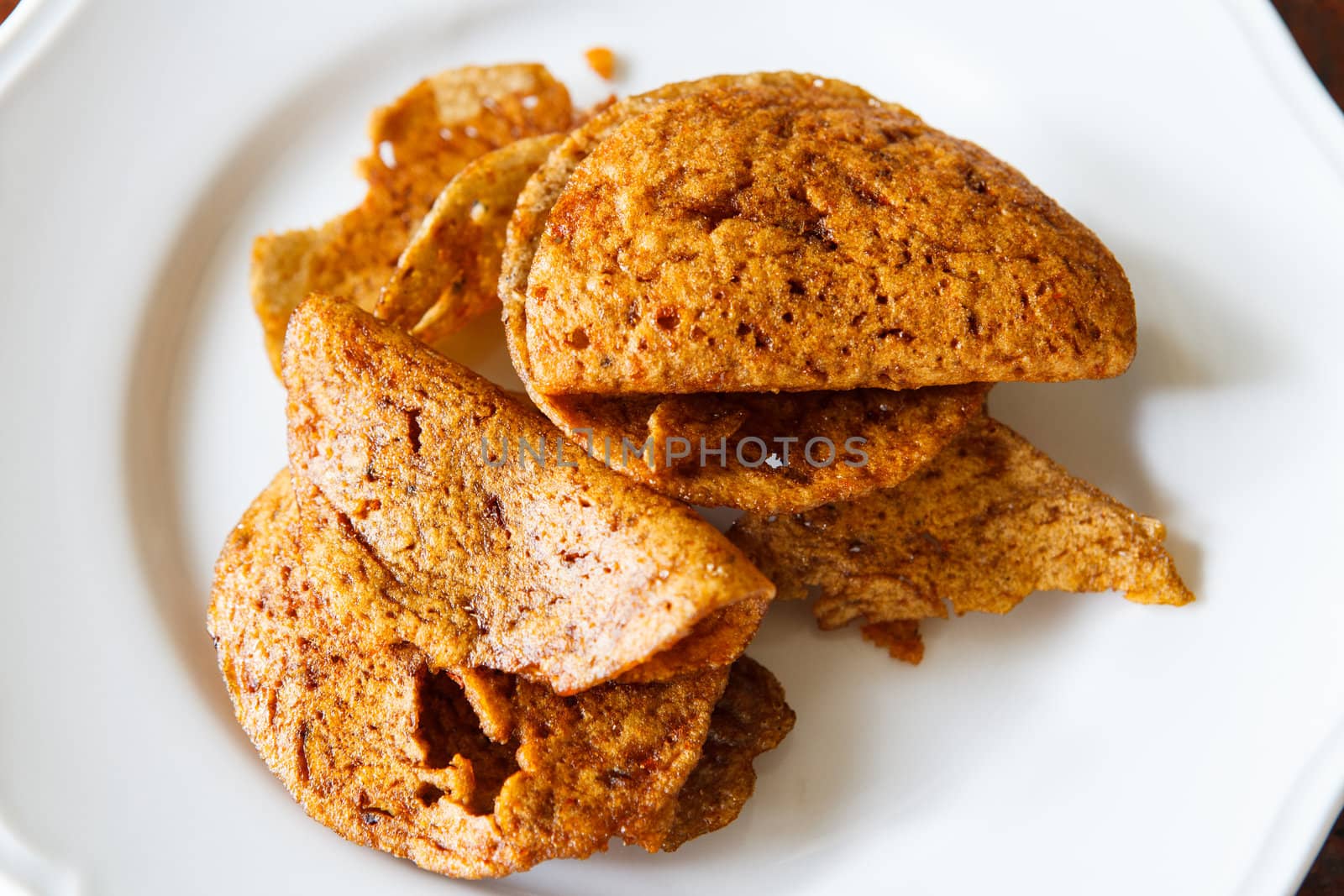 Crispy made from fish on white dish.