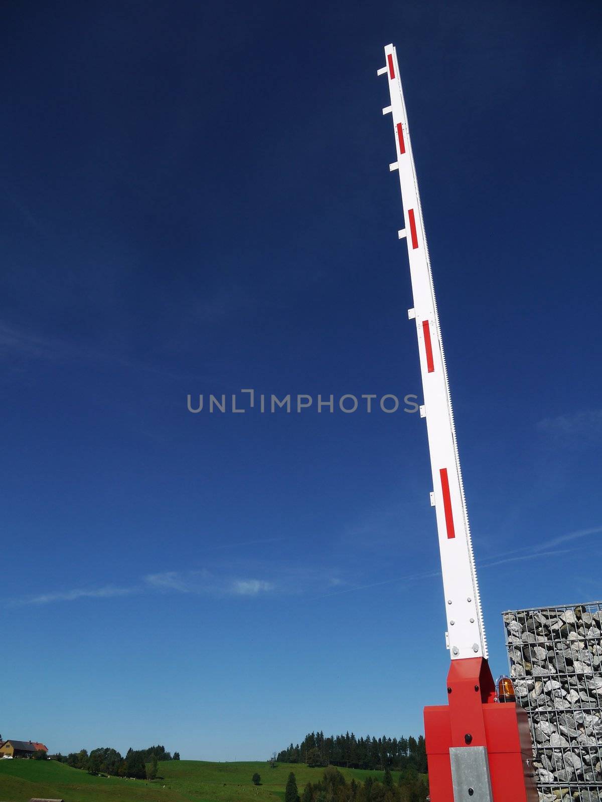 A red stop sign on a barrier and a big blue sky. by yucas