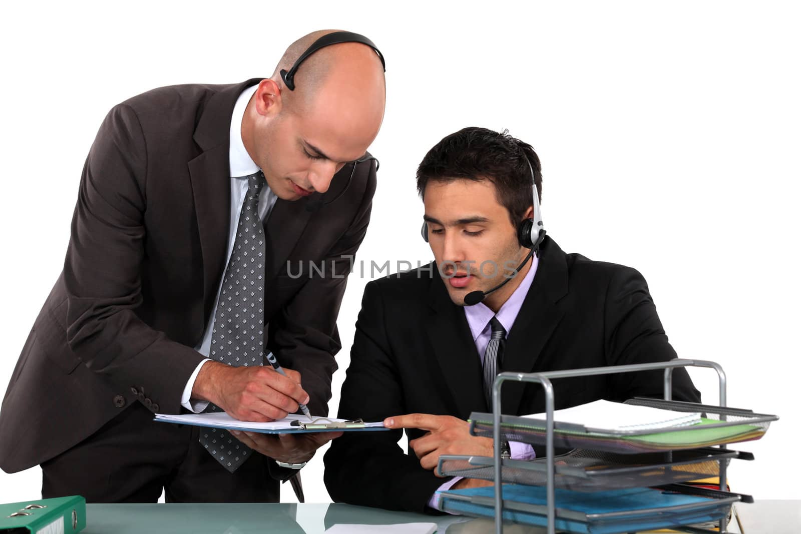 Office workers wearing headsets by phovoir