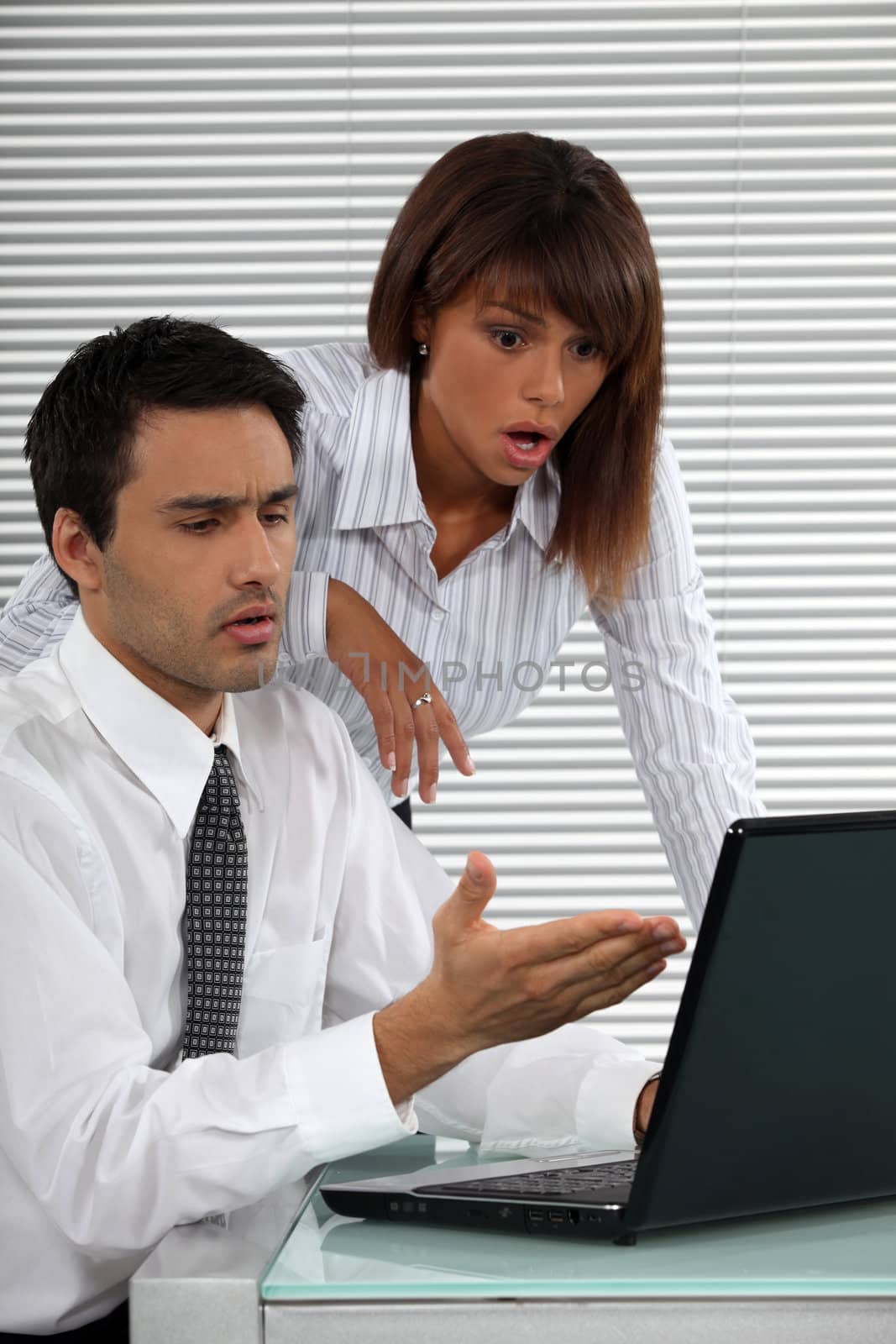 Two businessworkers shocked by laptop screen by phovoir