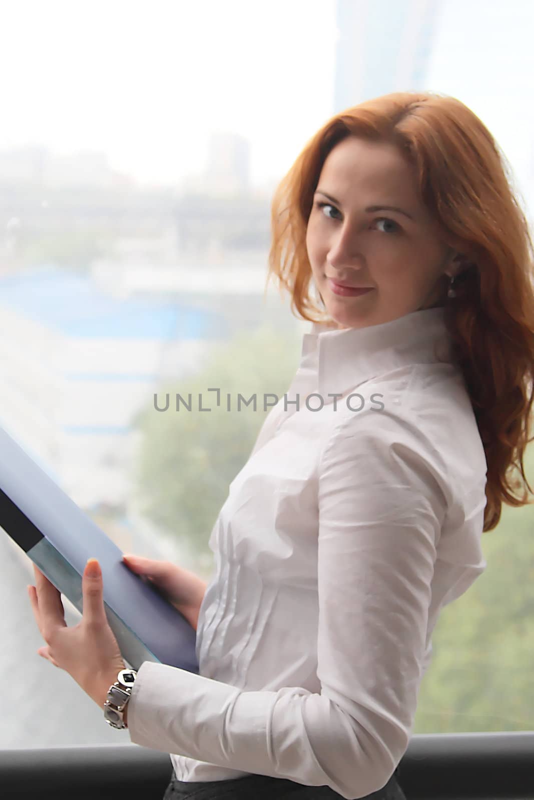 Portrait of the beautiful and young business woman