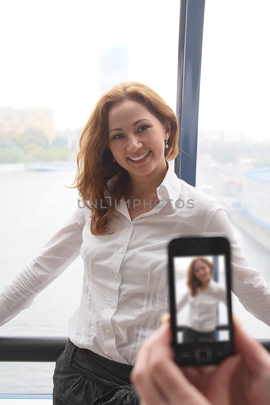 The girl photograph on a mobile phone
