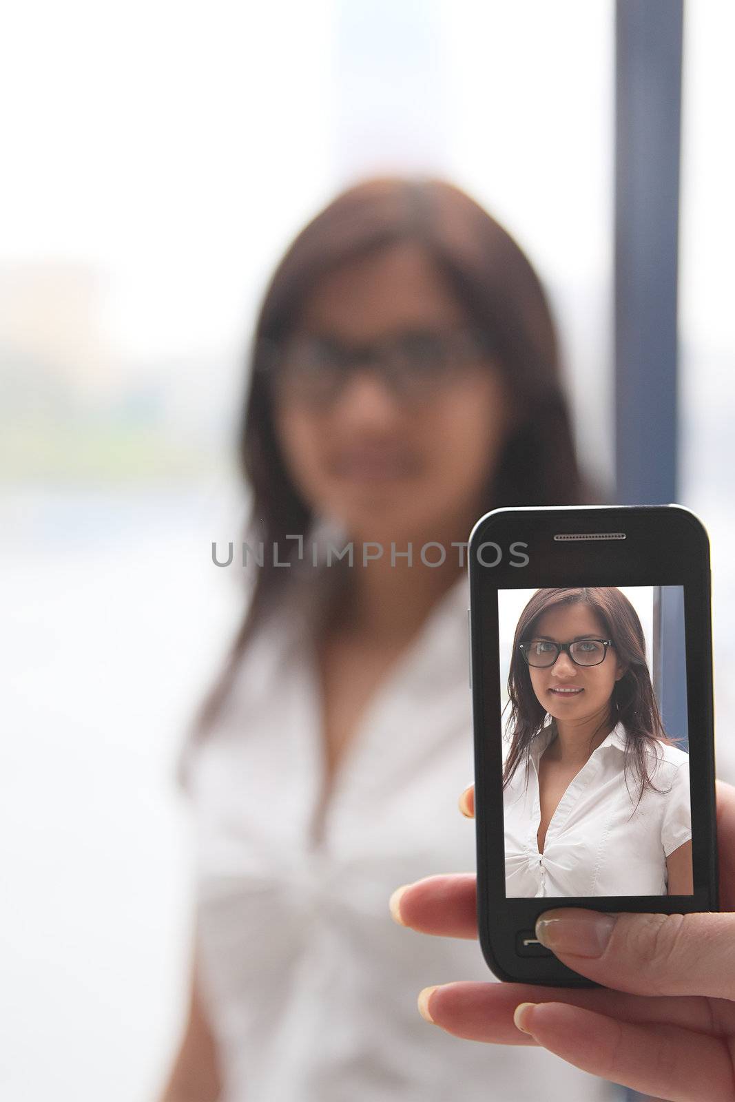 The girl photograph on a mobile phone