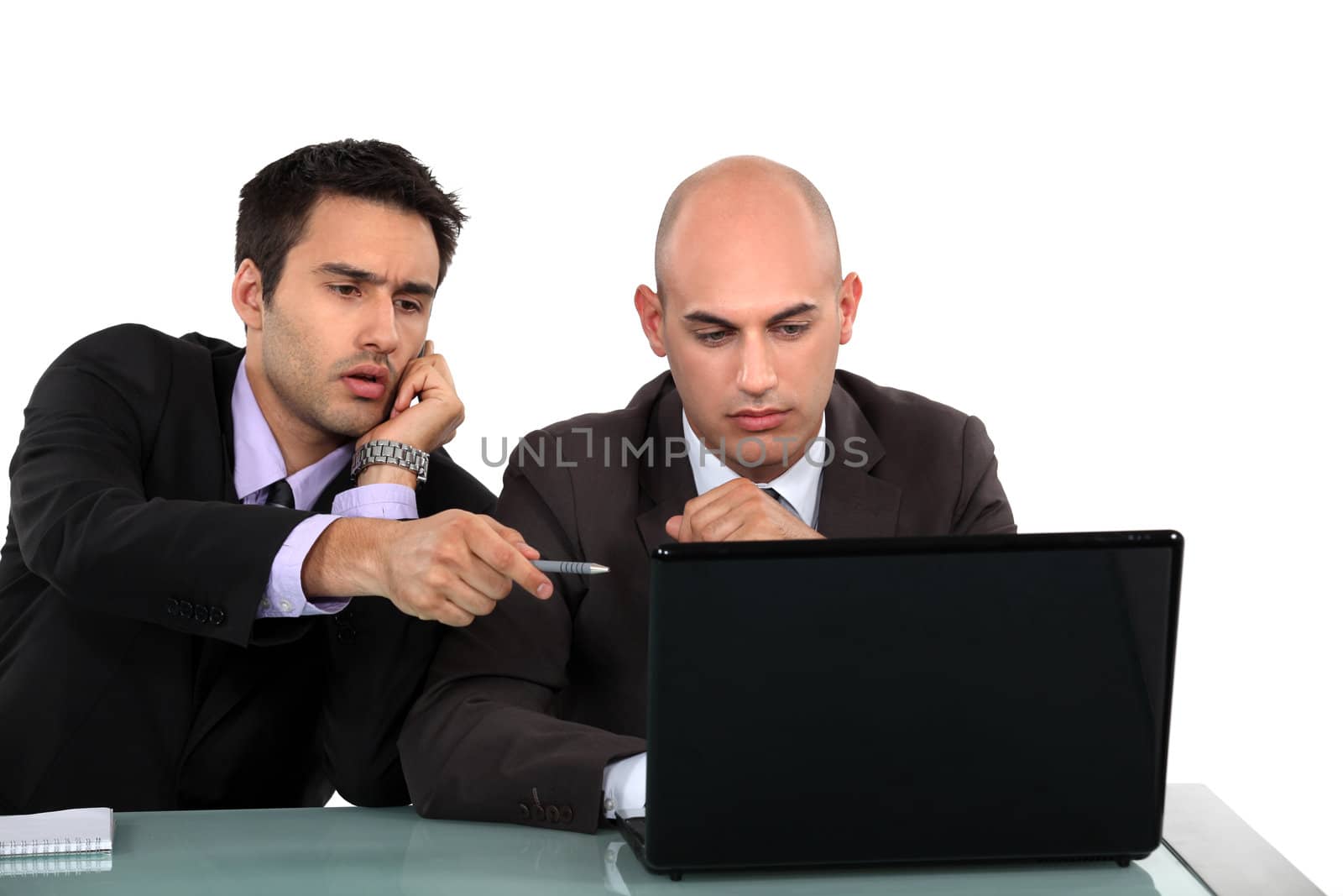 Executives discussing content on a laptop