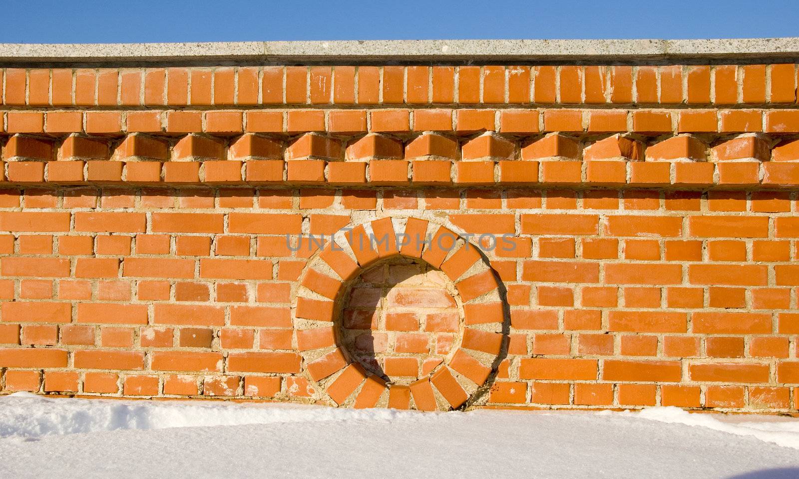 Red brick wall fragment details in winter. by sauletas