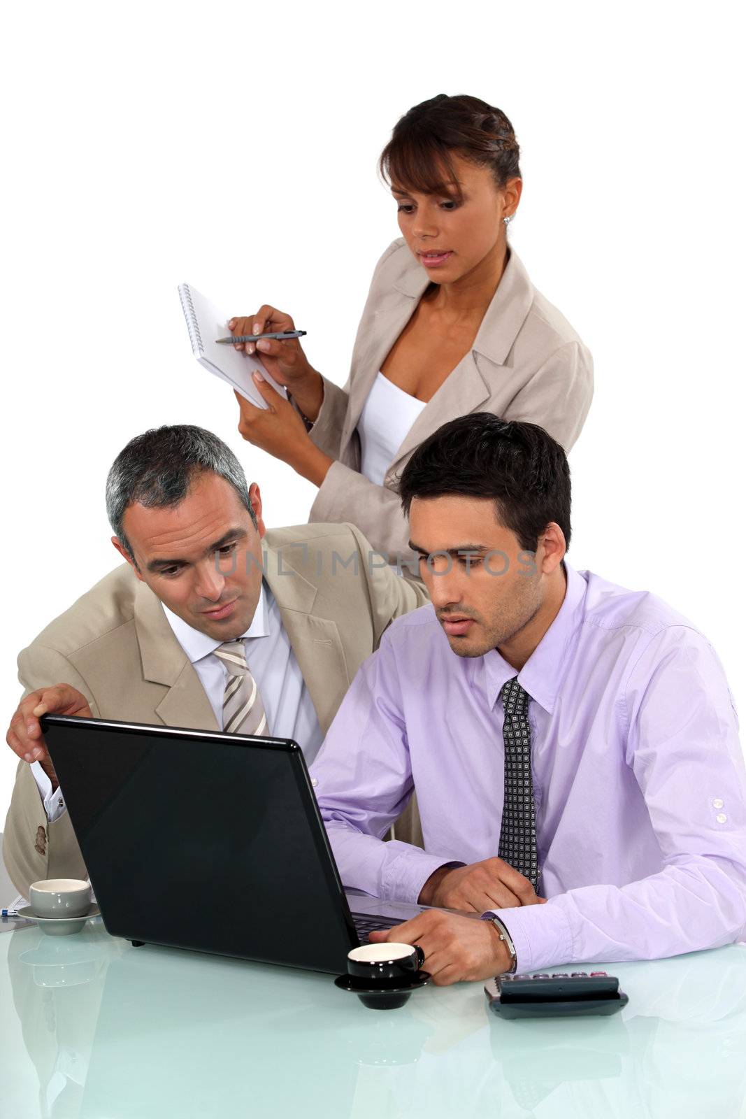 Sales team working on laptop by phovoir