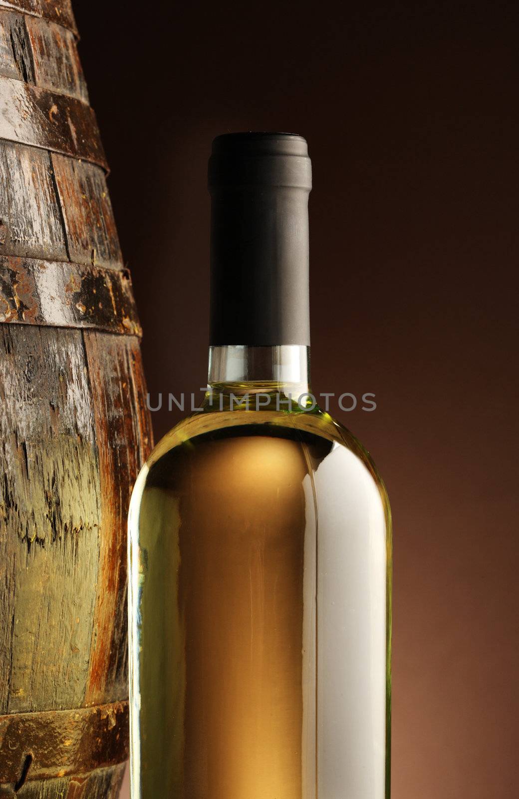 white wine bottle and woodden barrel
