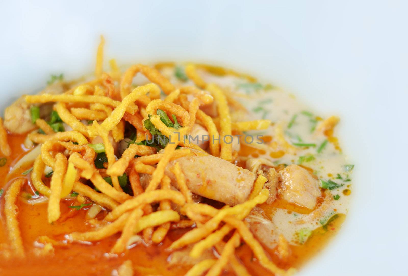 A noodle dish in a yellow curry with chicken. Khao soy a famous northern Thai food.