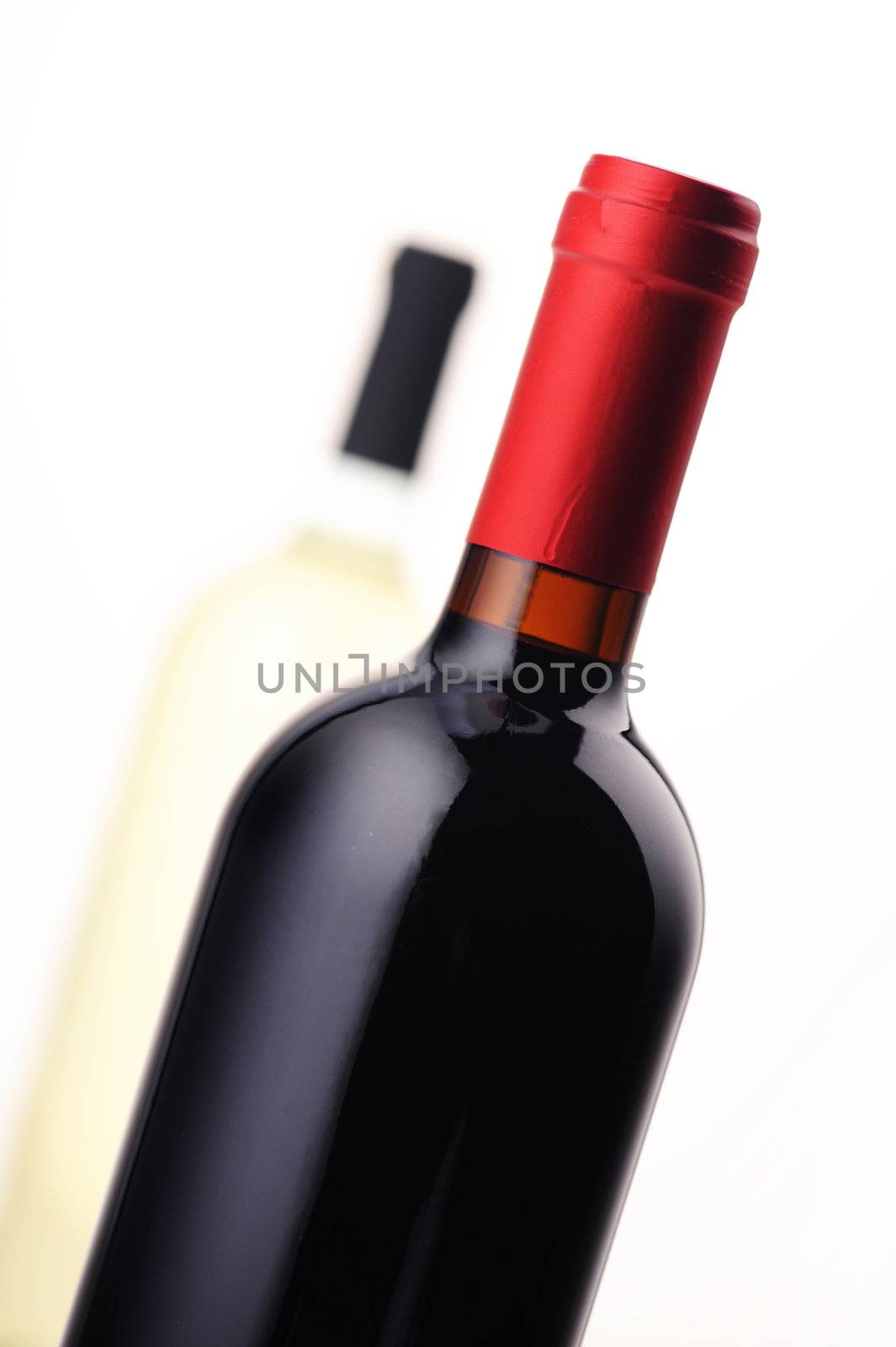 bottles of red and white wine on white background