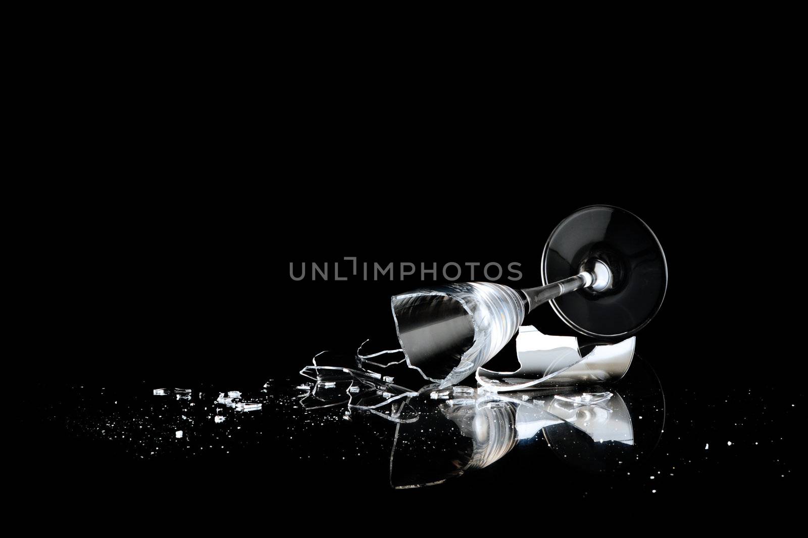 elegant wine glass broken on a dark background