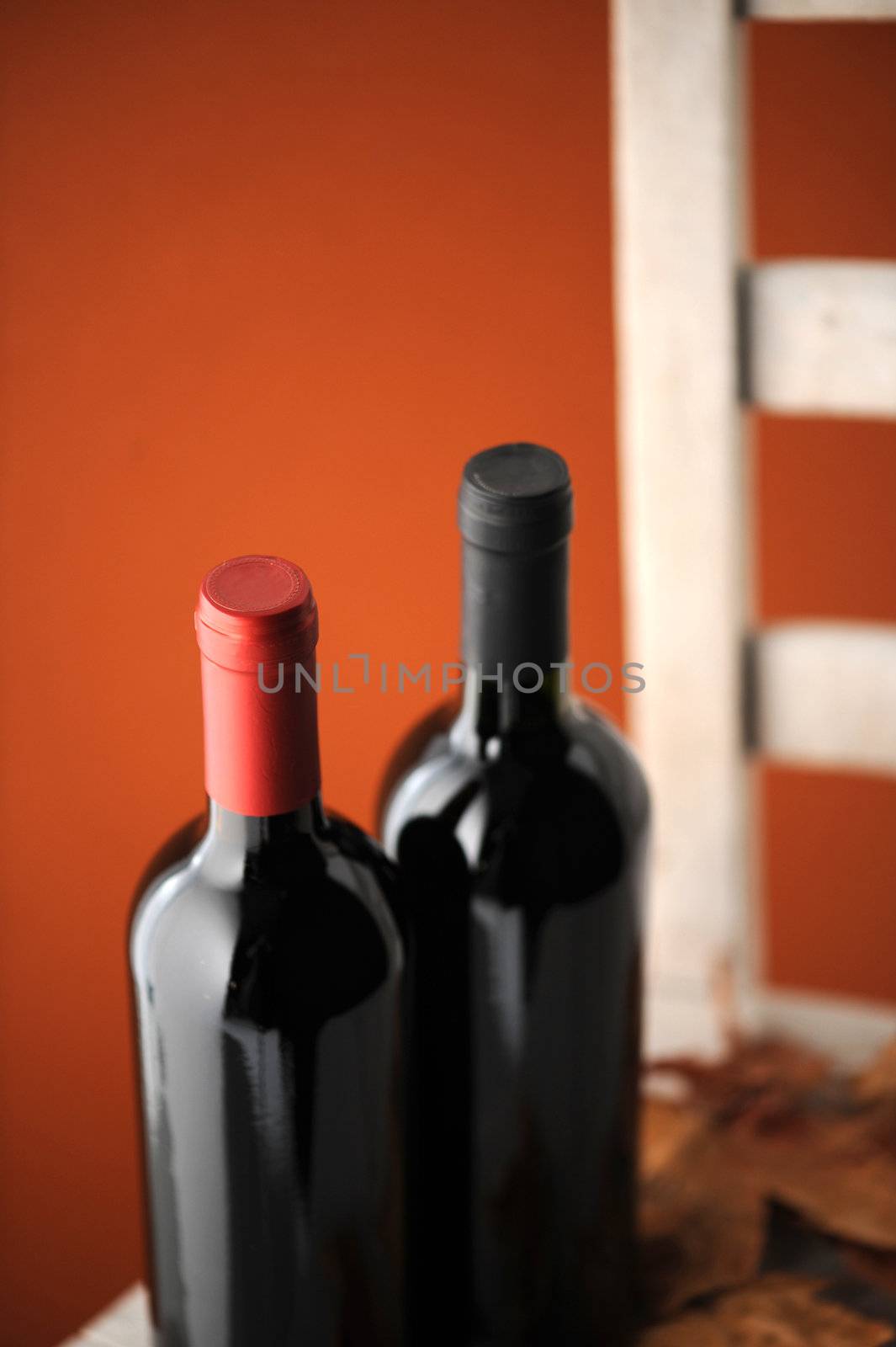  bottles of red wine on a white wooden chair (shallow dof)