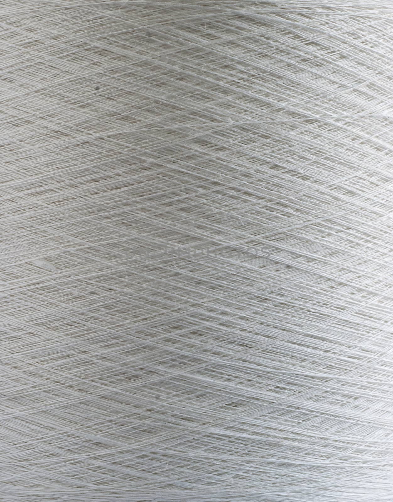 White linen yarn bobbin closeup detail as background
