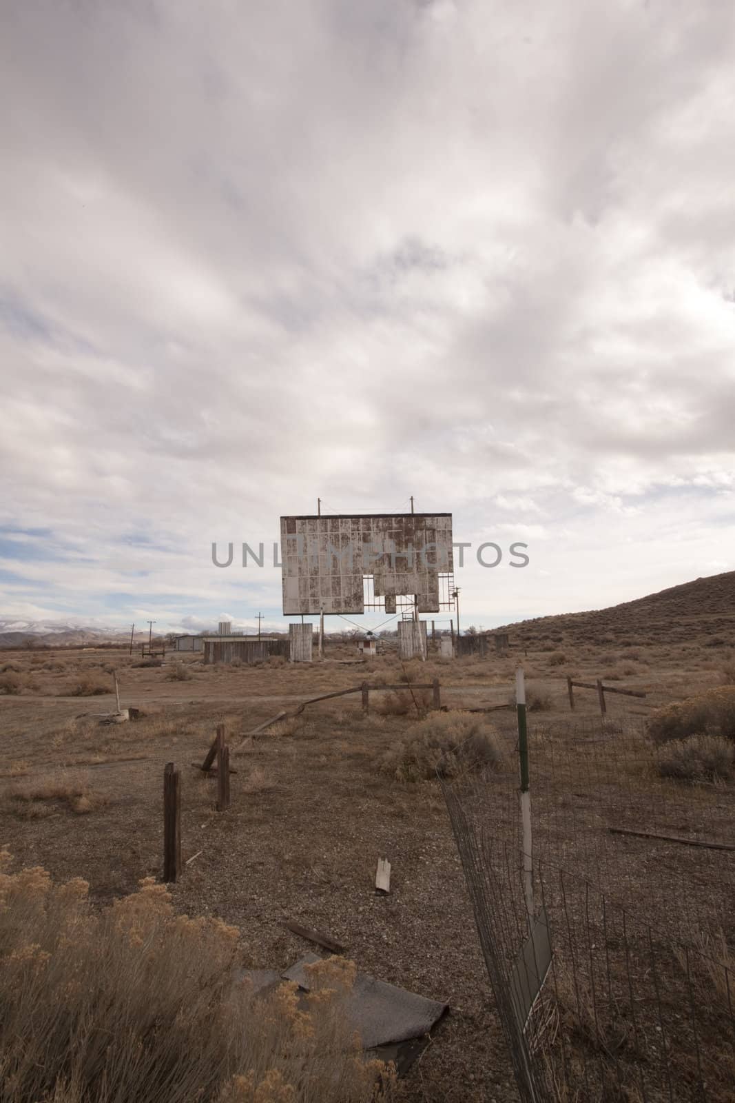 abandoned movie theater int he desert with clouds