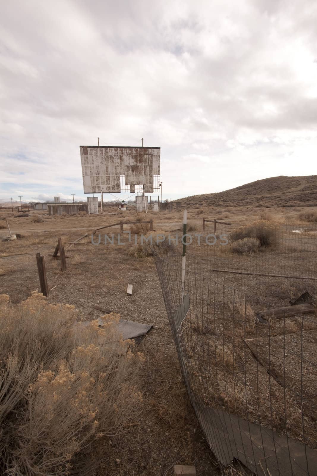abandoned movie theater int he desert with clouds
