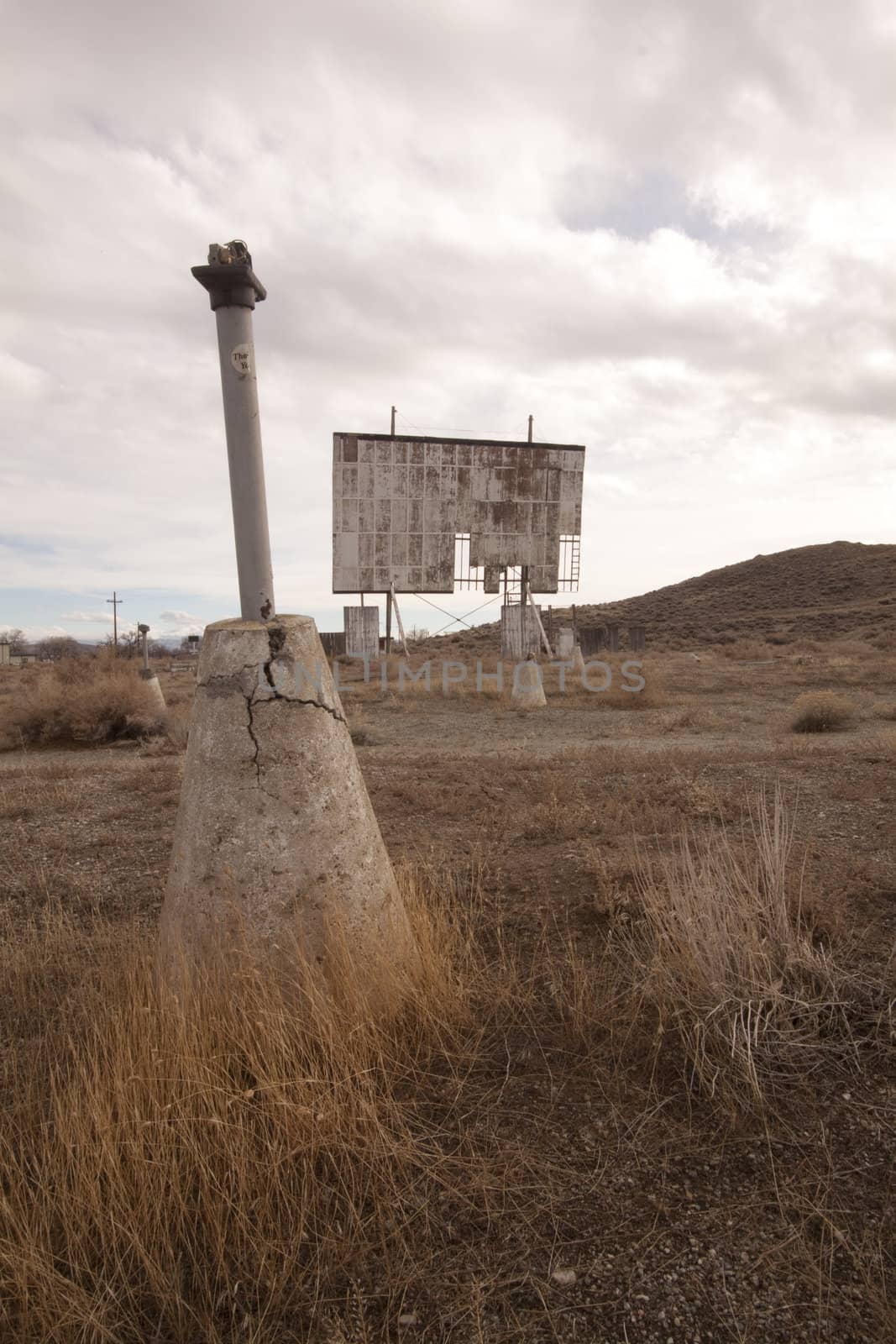 abandoned movie theater int he desert with clouds