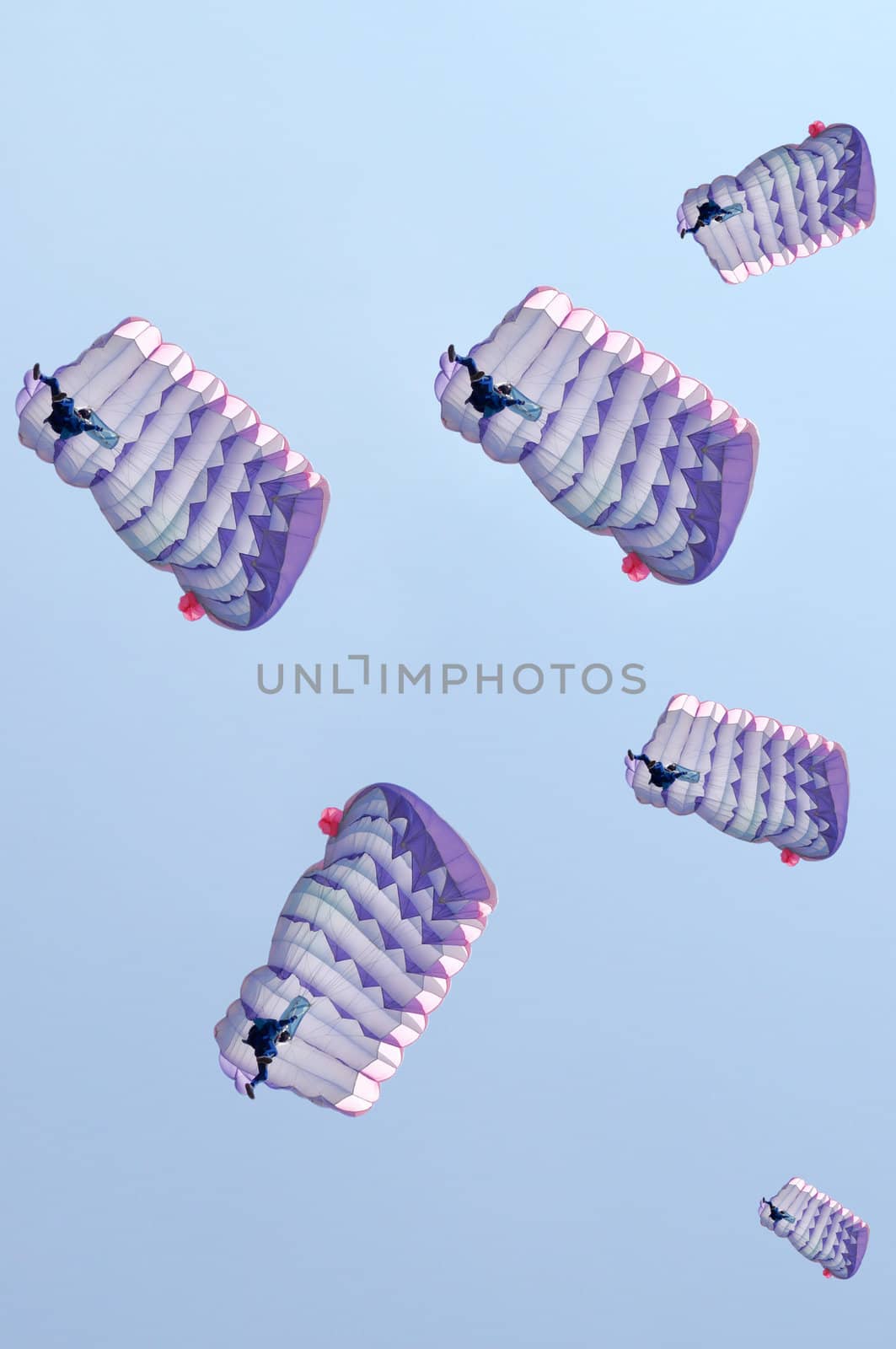 Many parachutes over a blue sky background