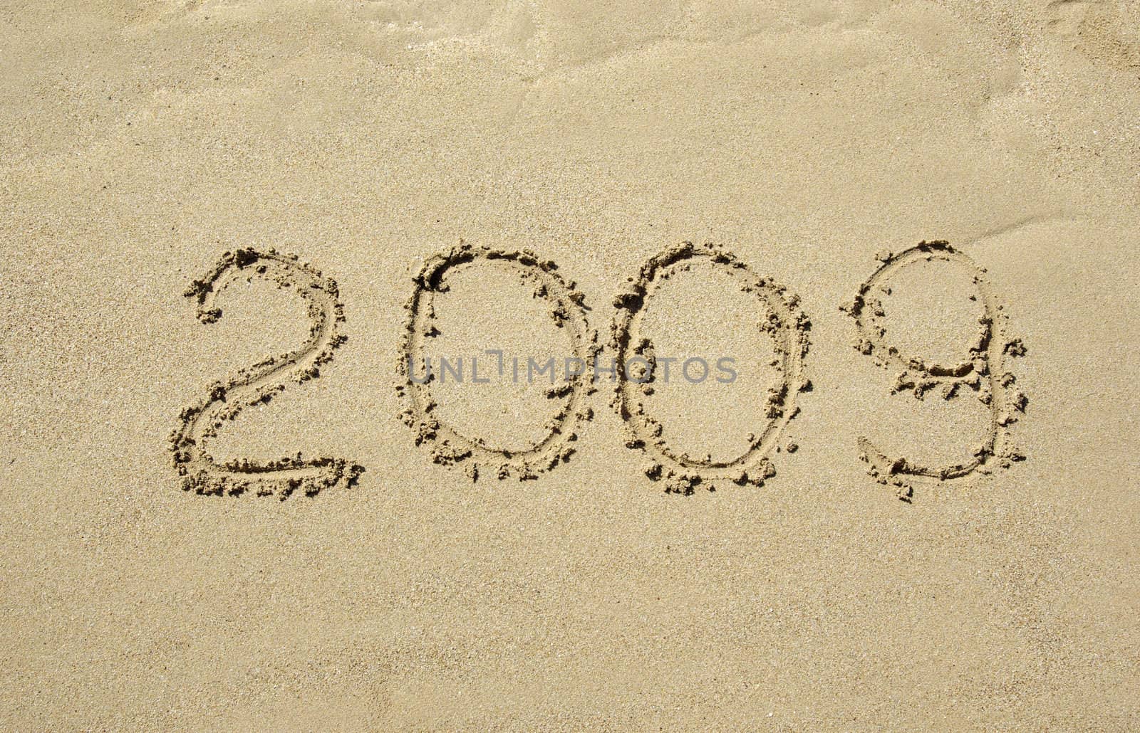 2009 Inscription on the sand of tropical beach.