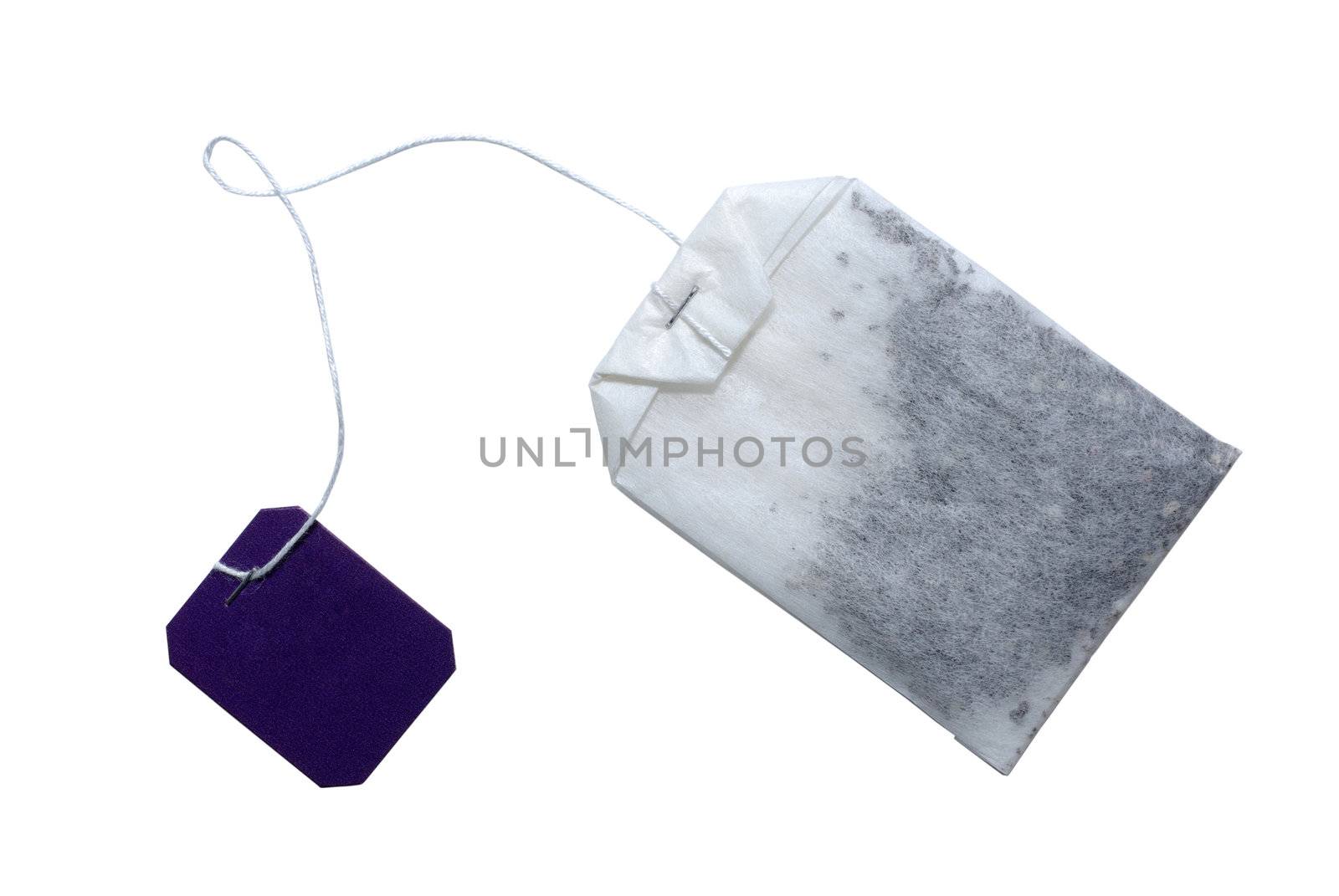 Tea bag with violet tag isolated on white. Clipping path included.