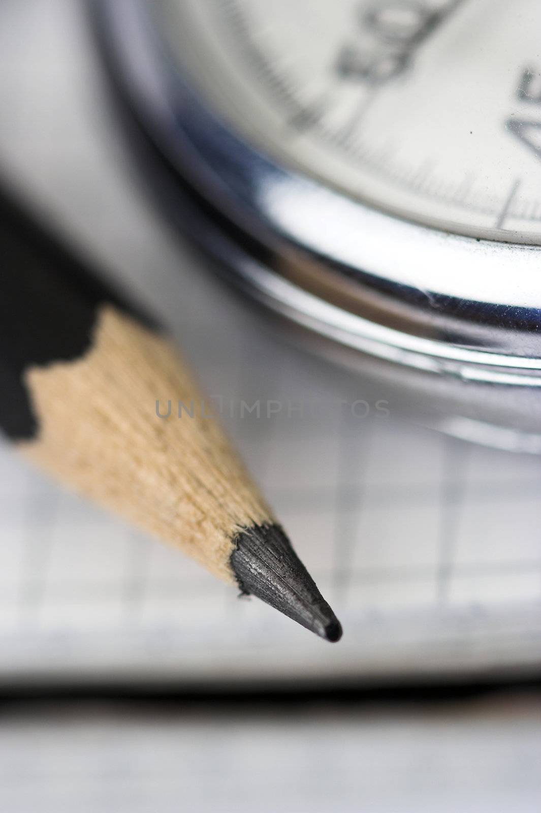 chronometer and black  pen over notebook