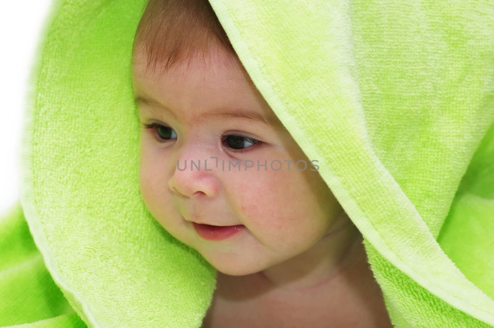 baby looking out from under blanket by dolnikow