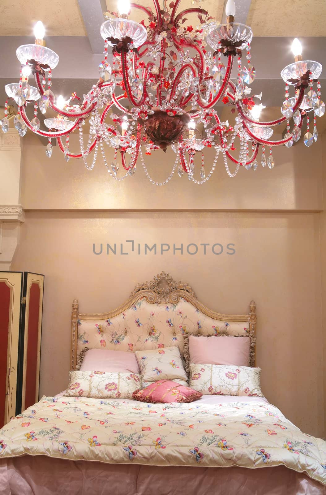 Interior of luxurious bedroom with red chandelier from crystal
