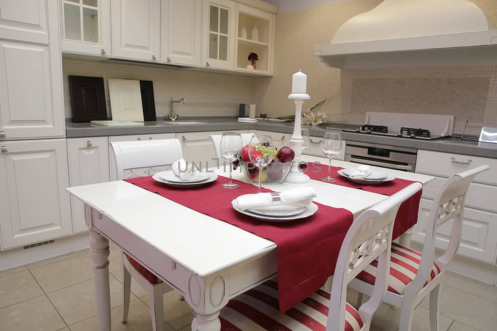 modern kitchen with white furniture in classical style and with served table