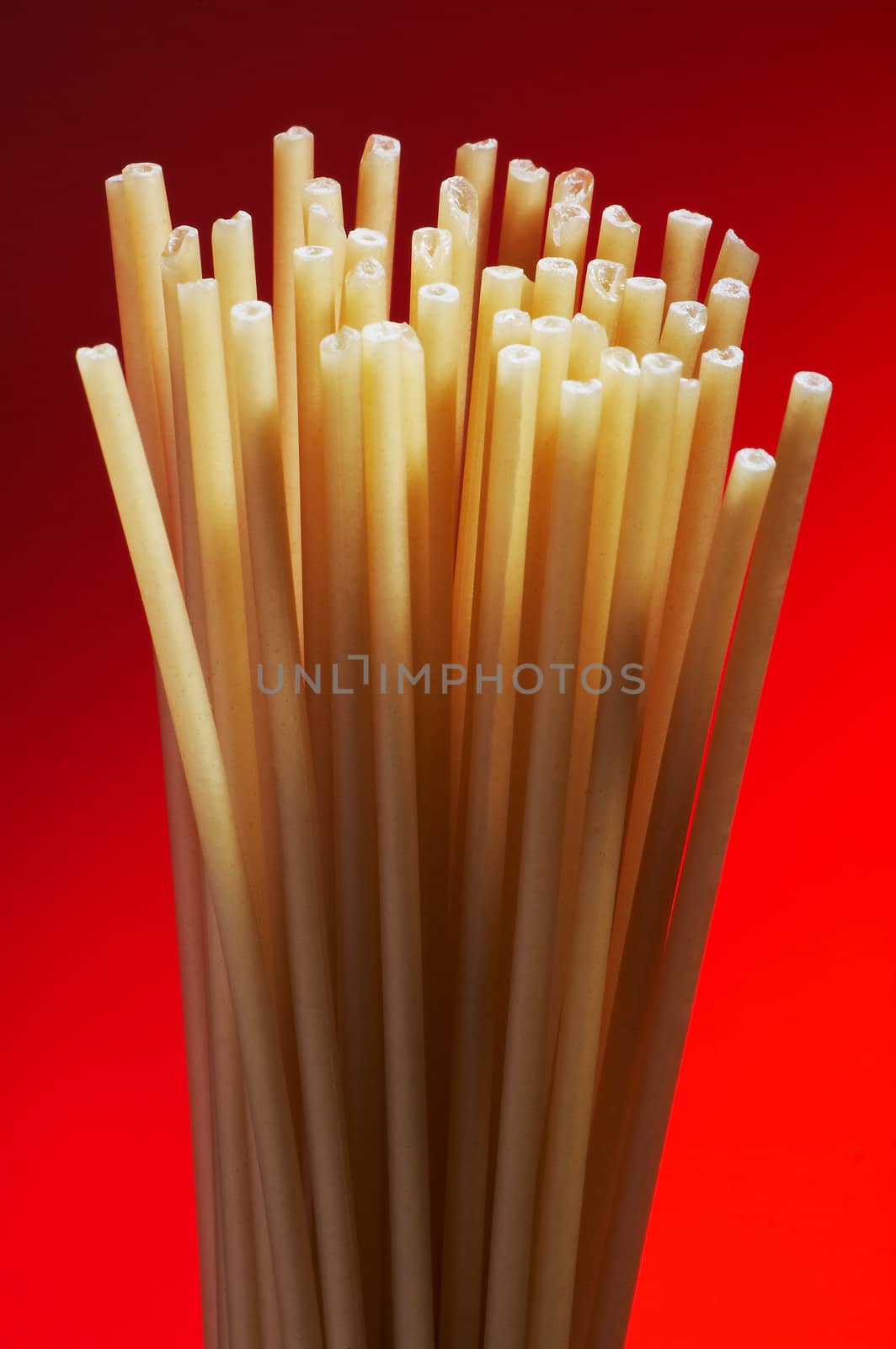 Some macaroni on a dark red background