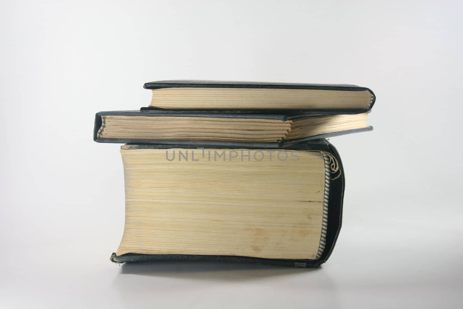 three old books closeup in white background profile