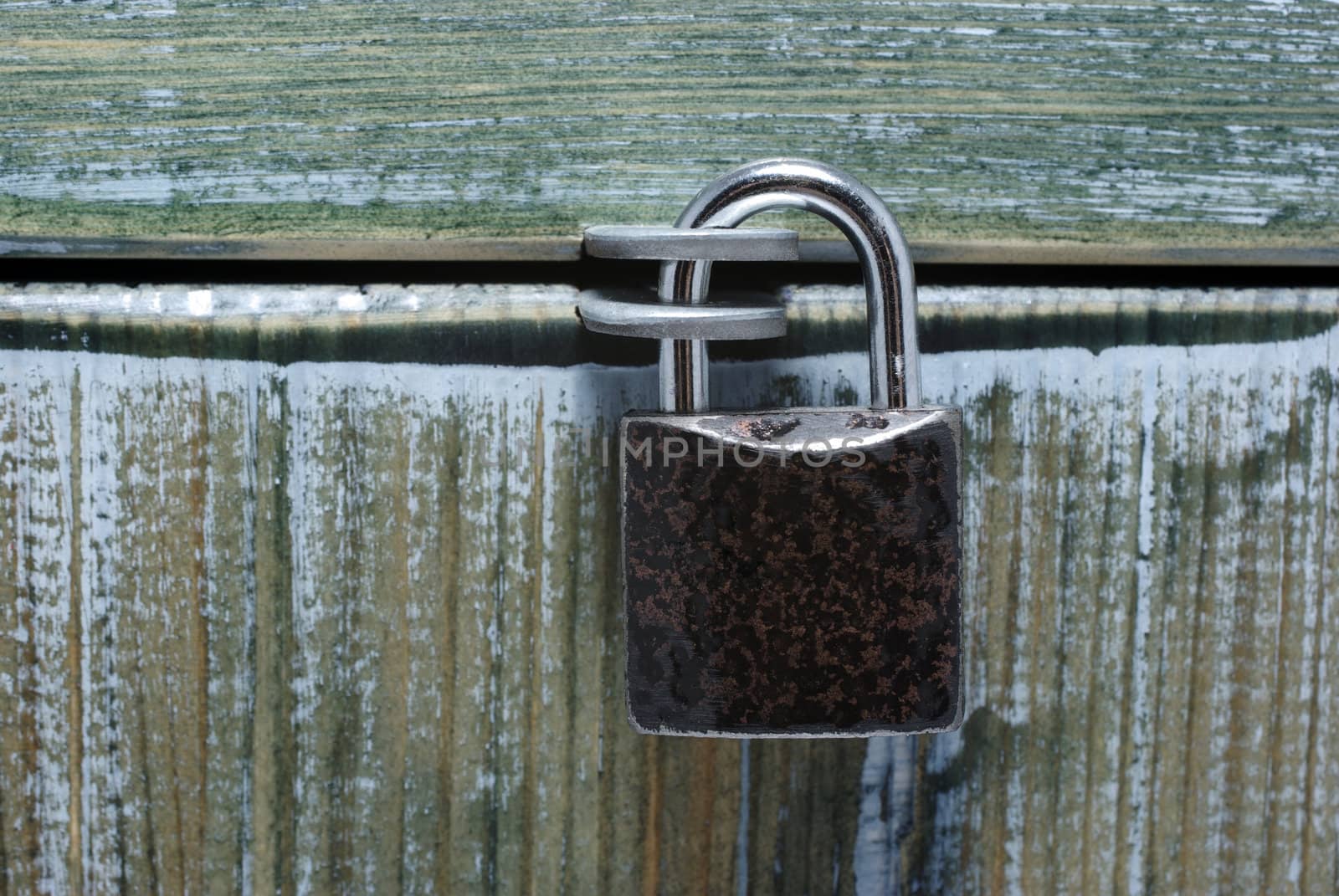 Padlock and closed painted old style box. Can be used as background or backdrop. Conceptual.