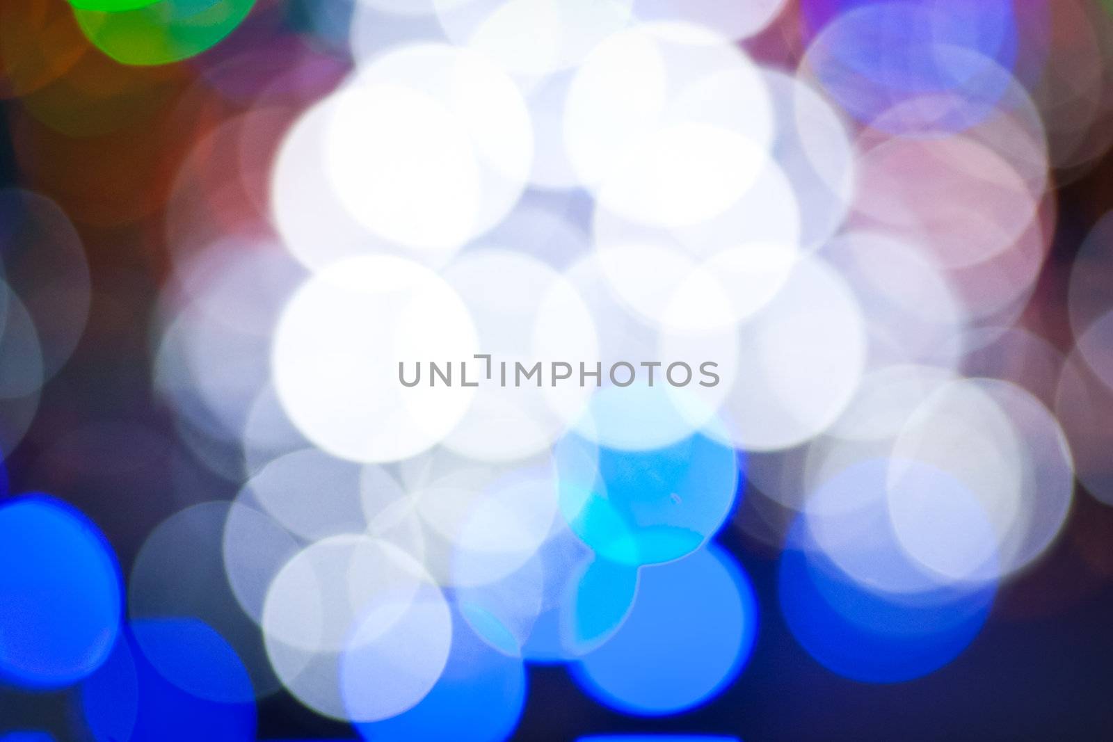 Christmas background with blurred dots in red, blue and golden colours
