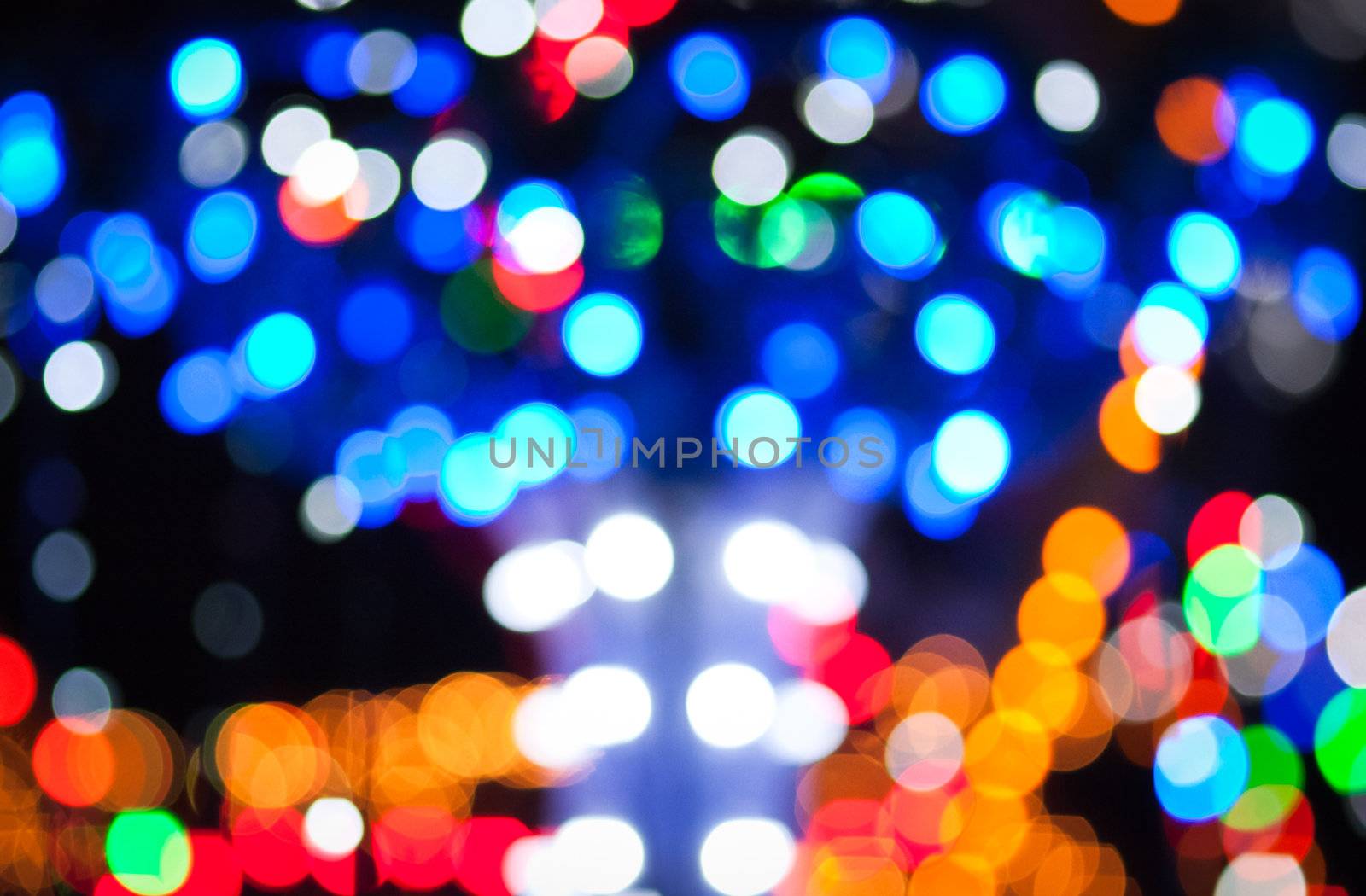 Christmas background with blurred dots in red, blue and golden colours