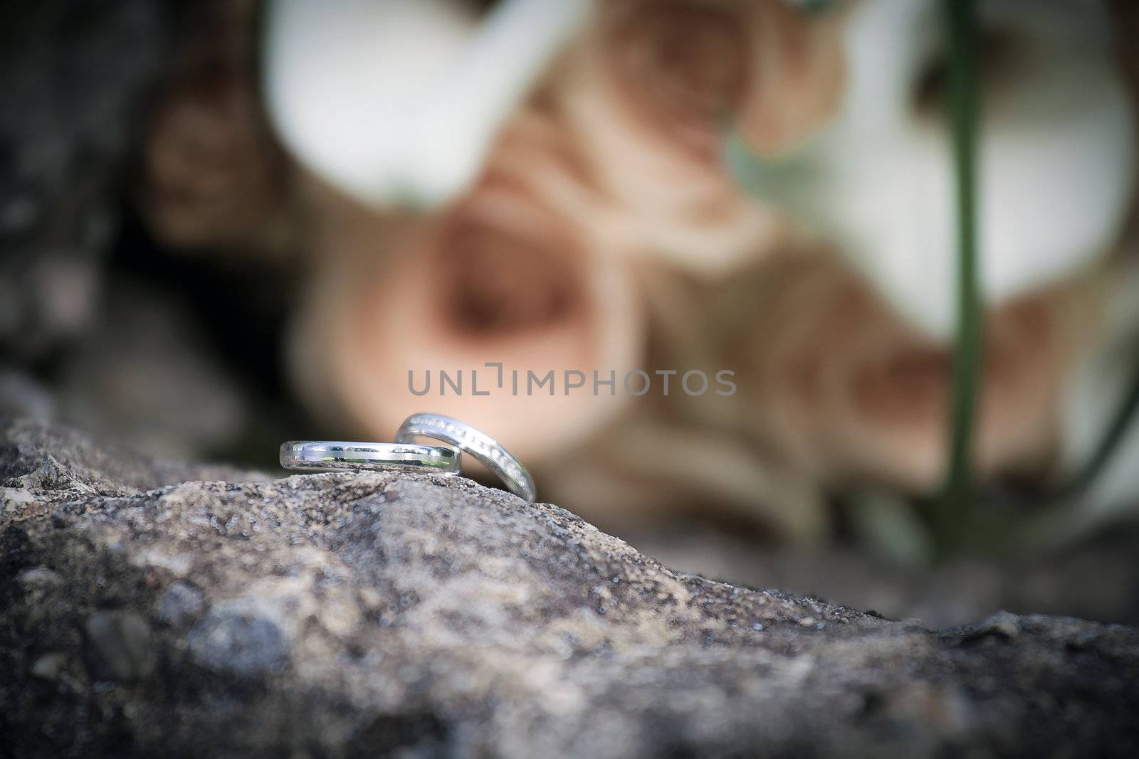 Wedding rings and  roses bouquet