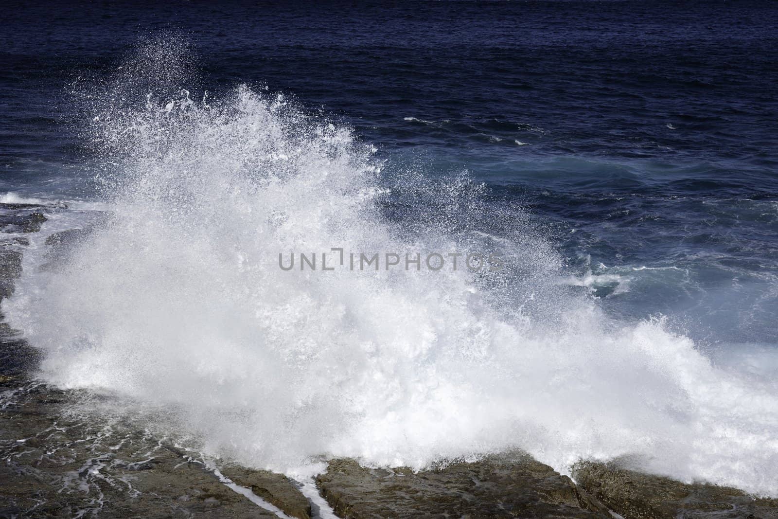 ocean waves crashing on rocks by clearviewstock
