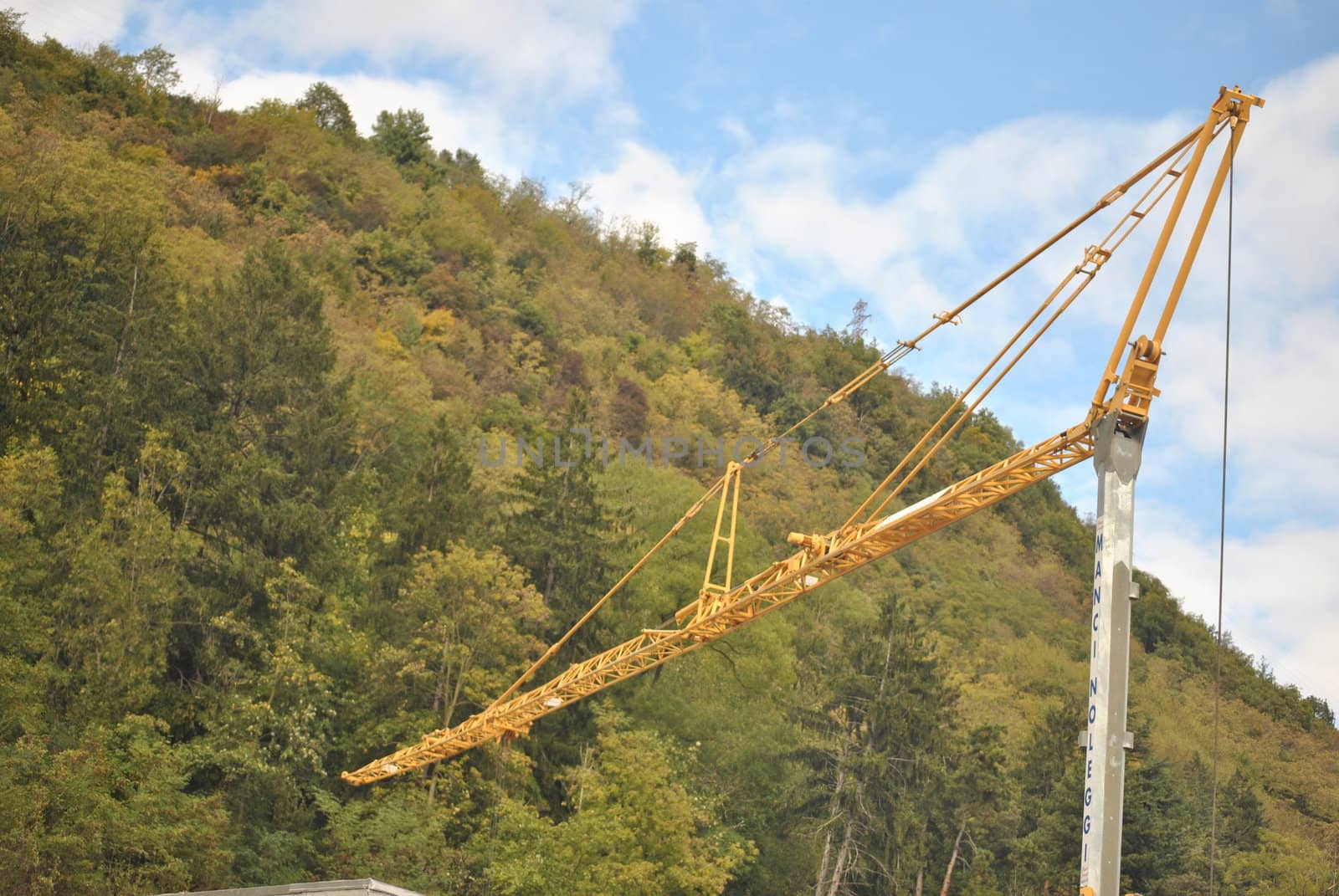 the yellow crane at the construction site near the hospital of St. Lawrence in Borgo Valsugana, in the province of Trento