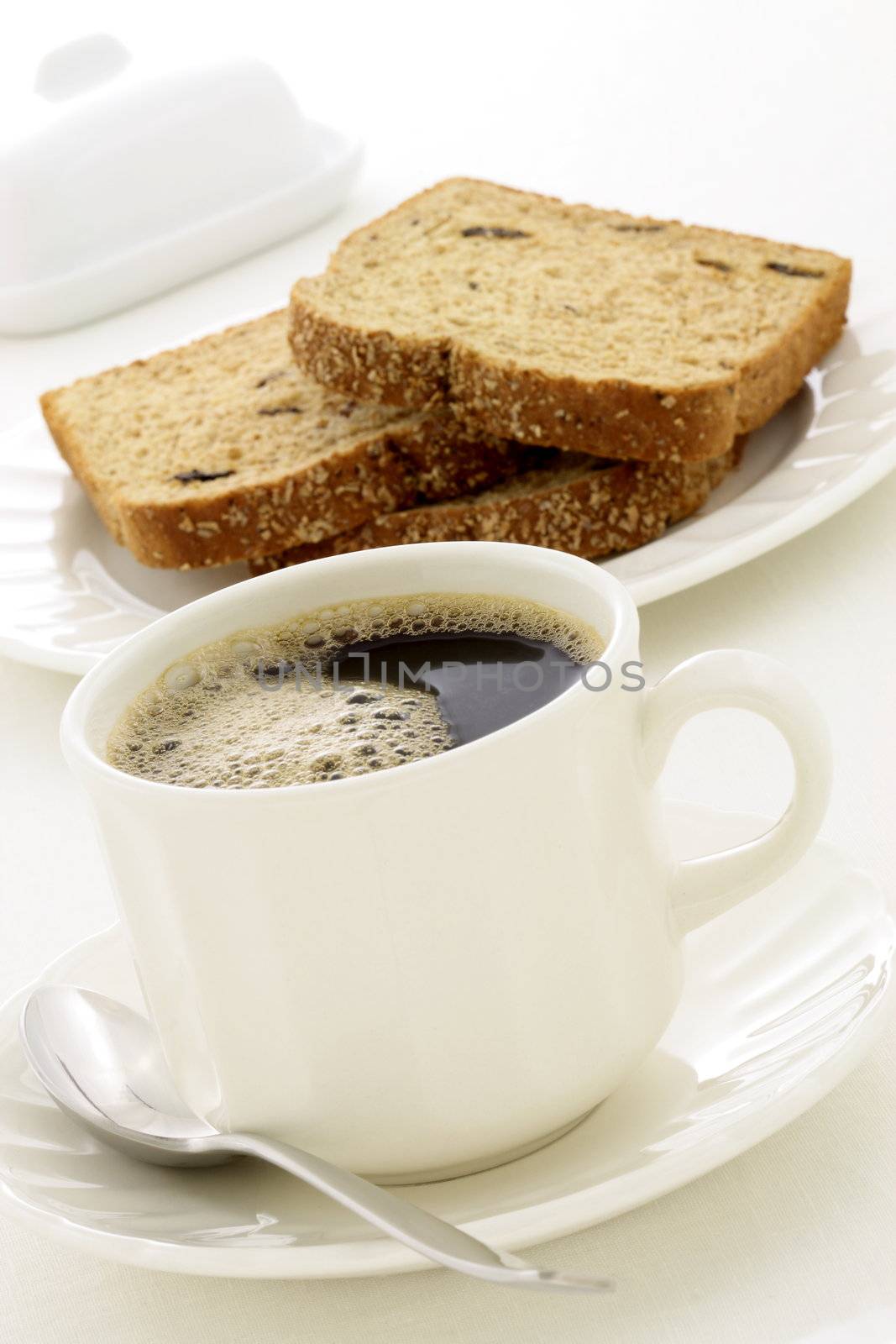 delicious breakfast with fresh hot coffee, butter and whole grain bread.