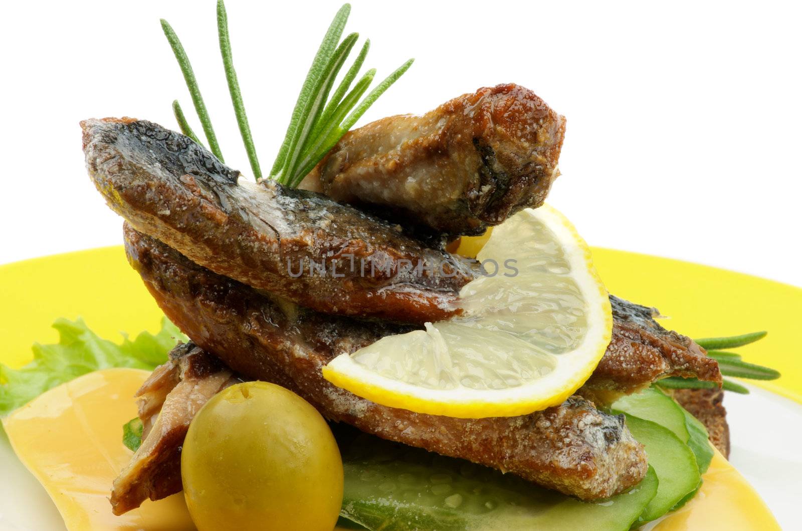 Snack of Smoked Sardines,  Lettuce, Cucumber, Cheese, Olives with Lemon and Rosemary closeup on Yellow Plate