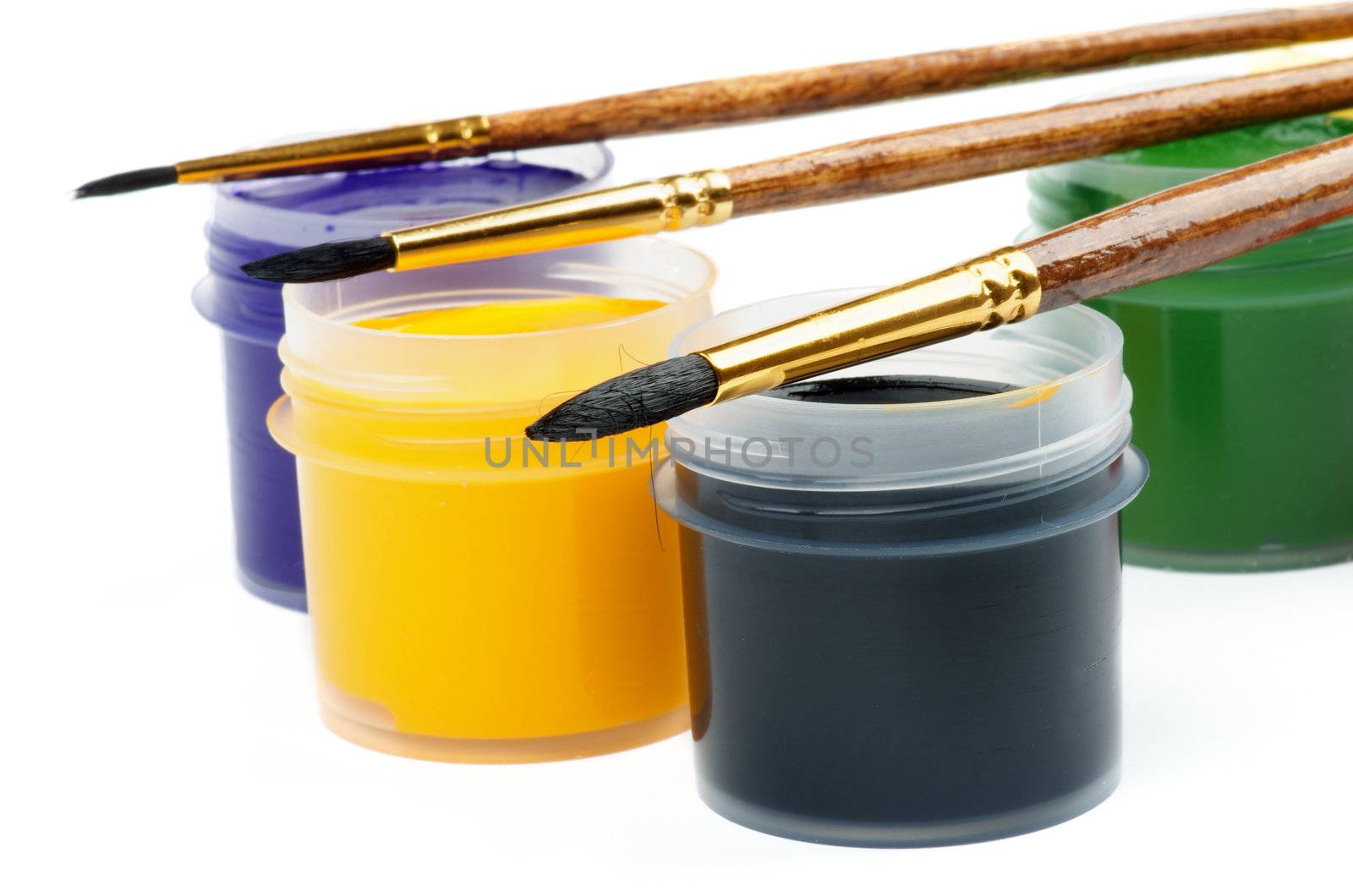 Containers with Black, Yellow, Purple and Green Watercolors with Paintbrushes closeup on white background